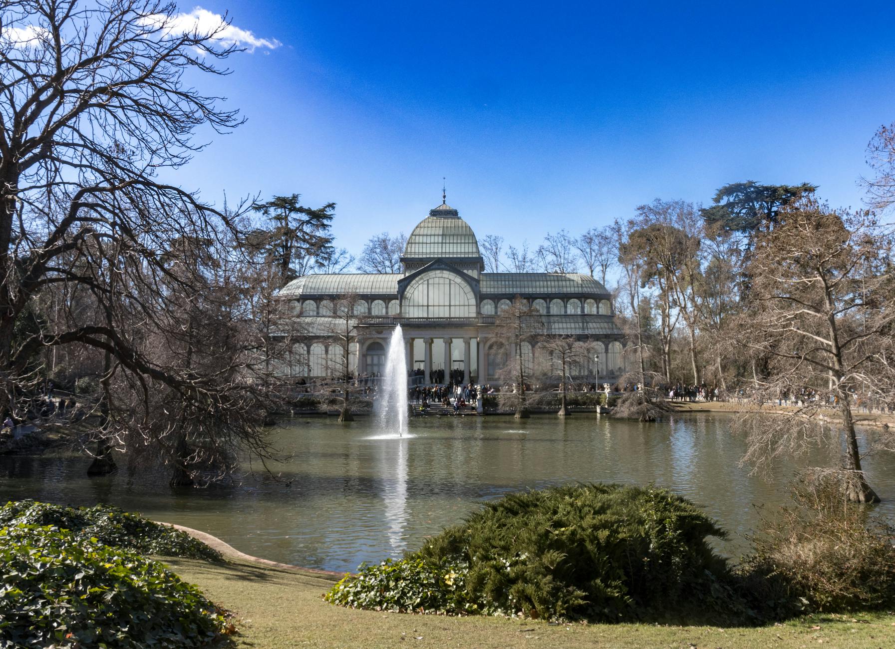 Crystal Palace in Retiro Park with pond and fountain