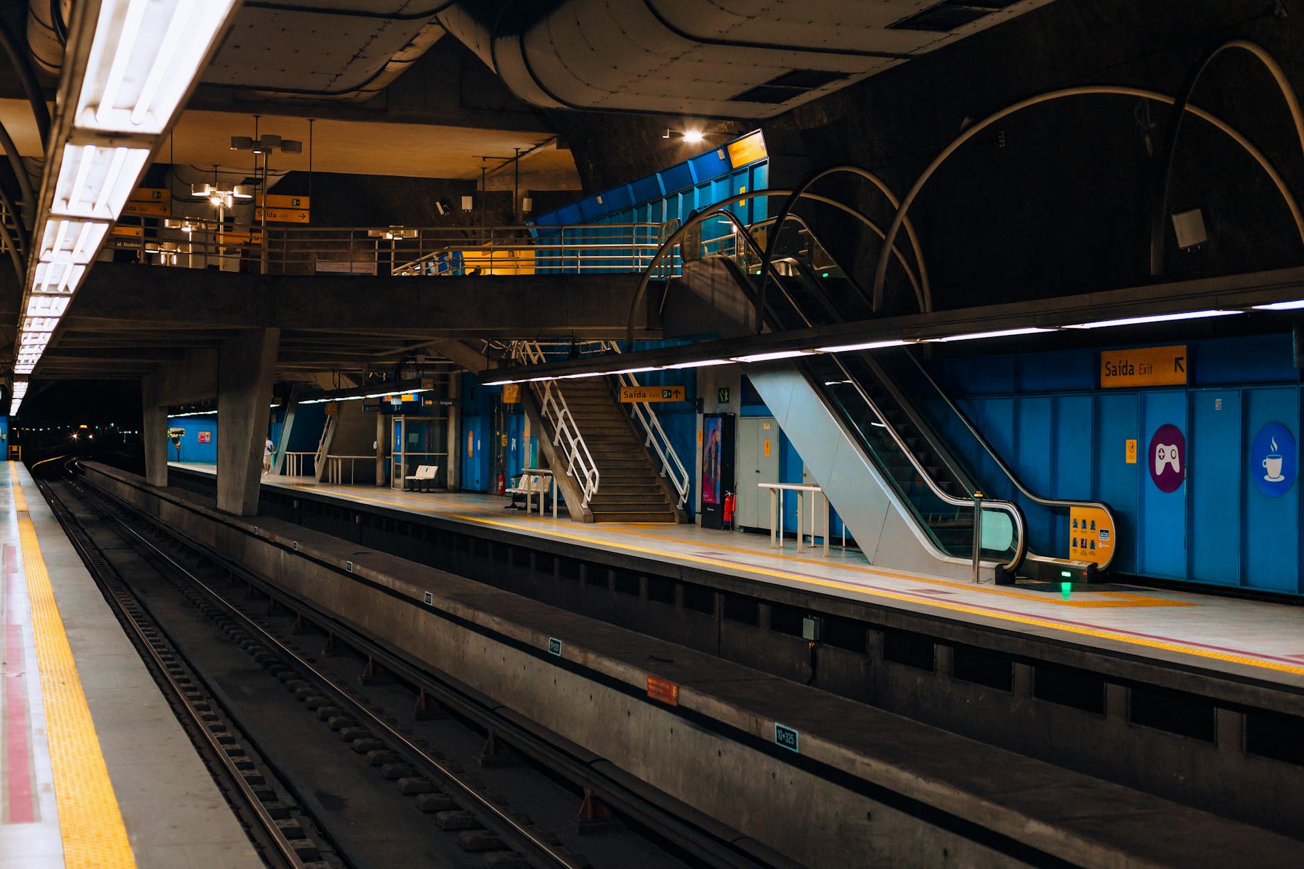 Madrid subway station platform with escalators and lighting