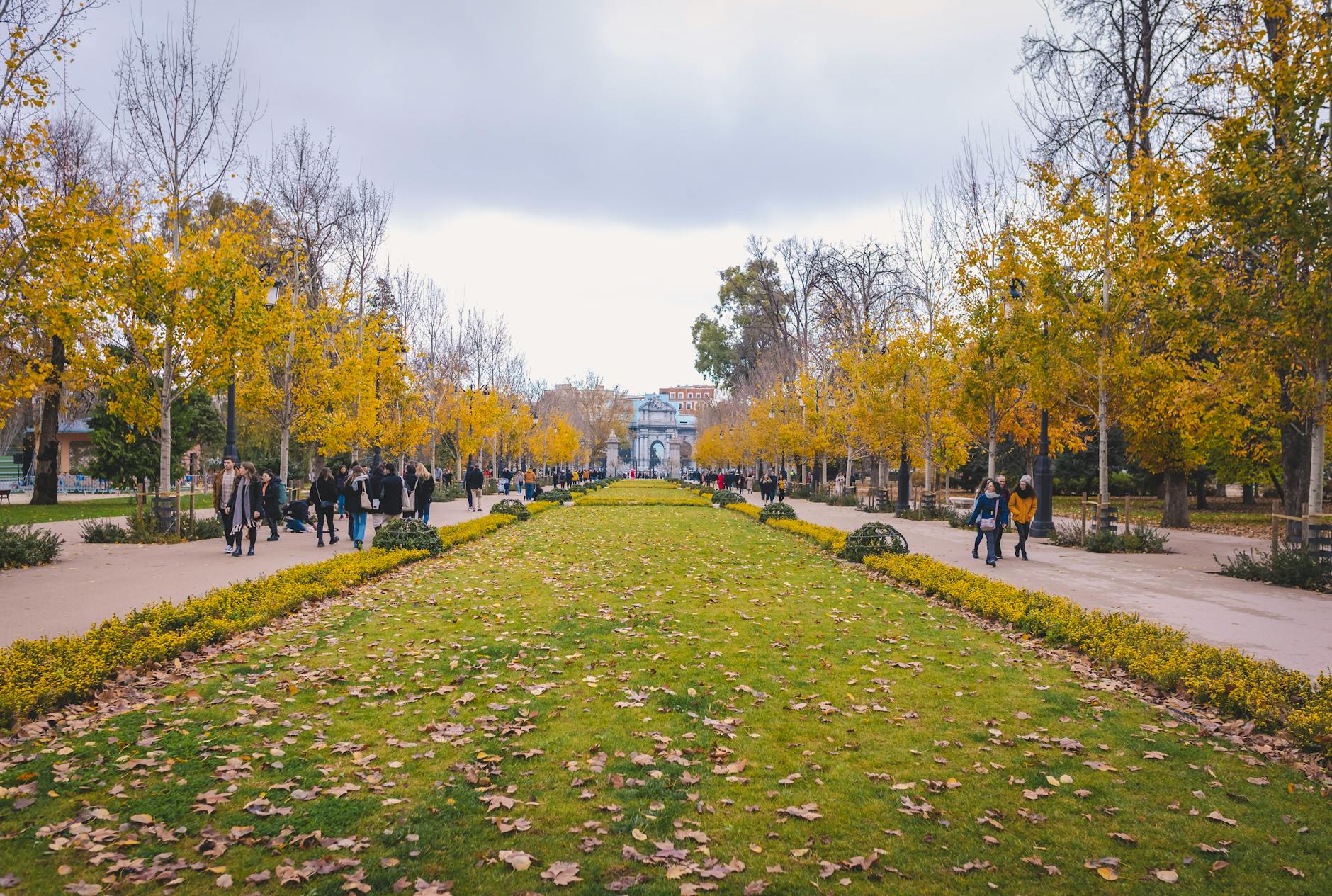 People walking through Retiro Park in Madrid in autumn