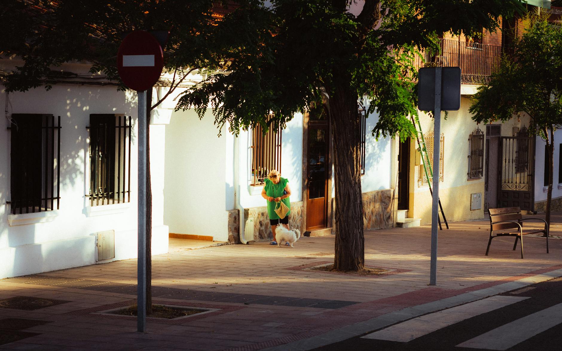 Residential Madrid sidewalk with apartment buildings and local street life