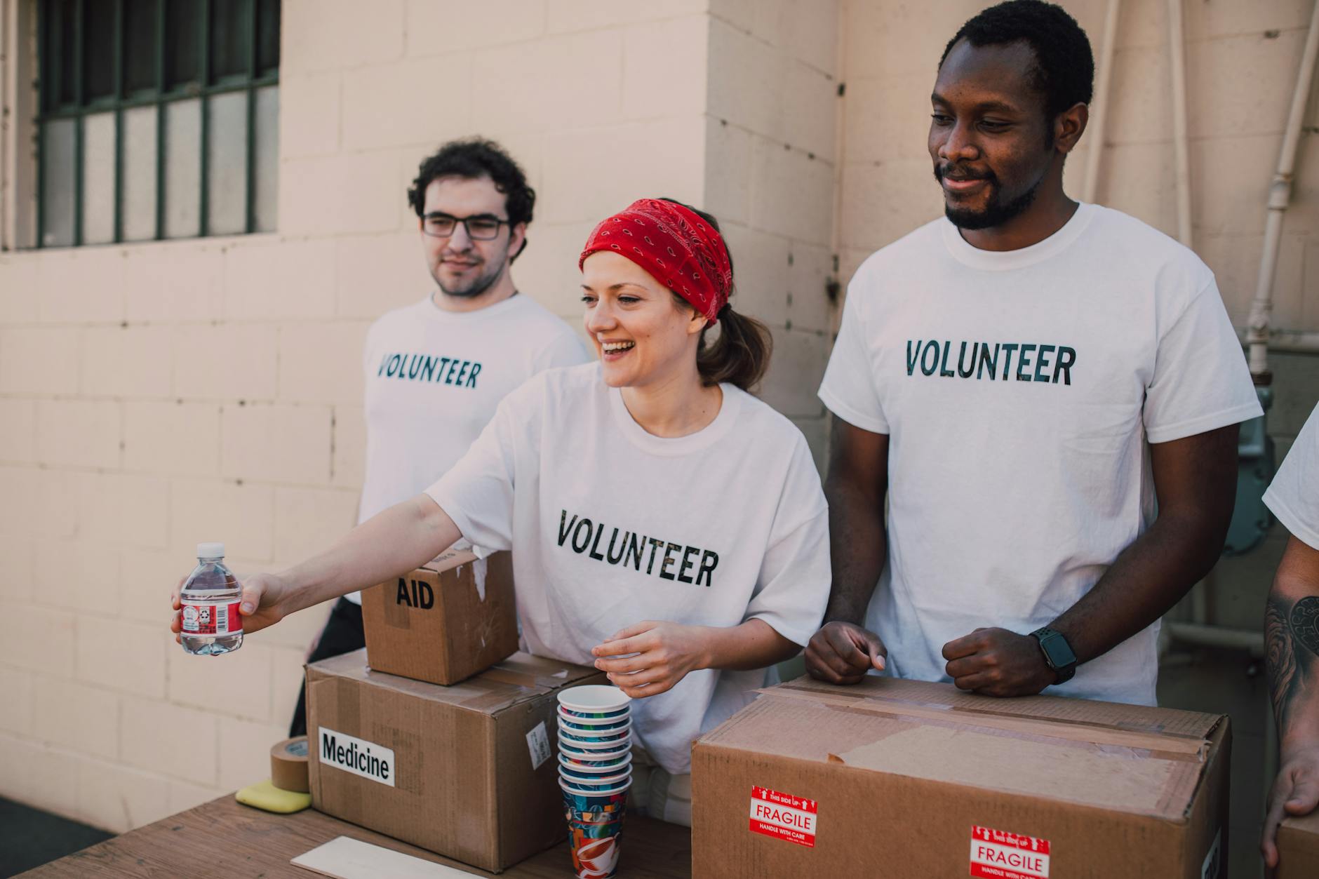 Volunteers distributing aid at an outdoor donation center
