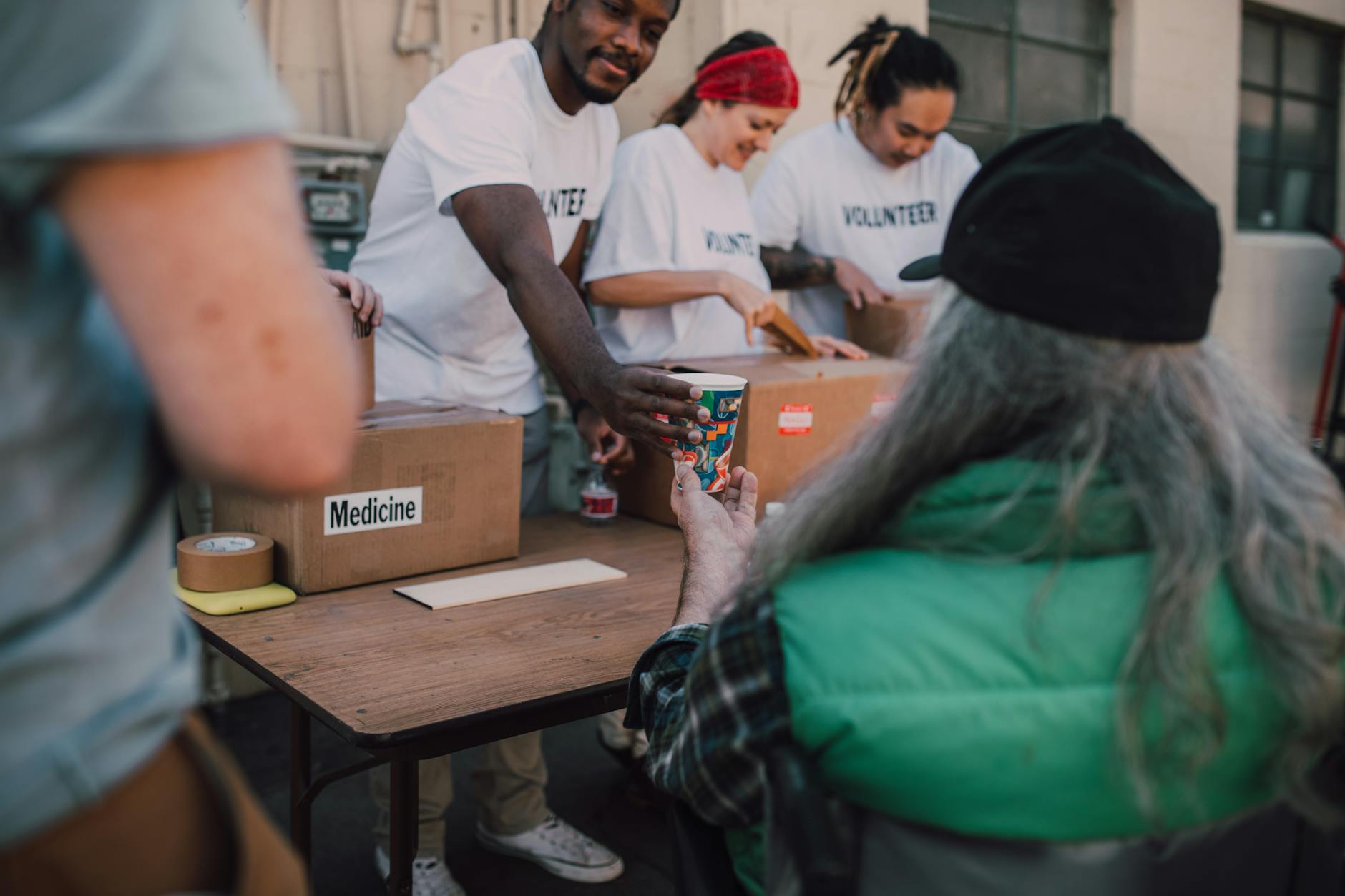 Volunteers handing out donations and support at a community event