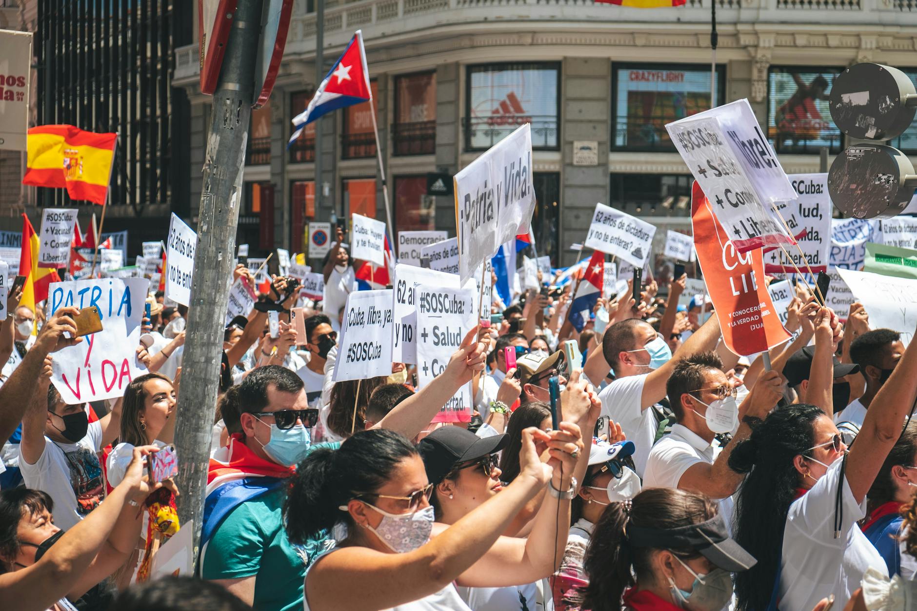 Street protest in Madrid with flags and placards