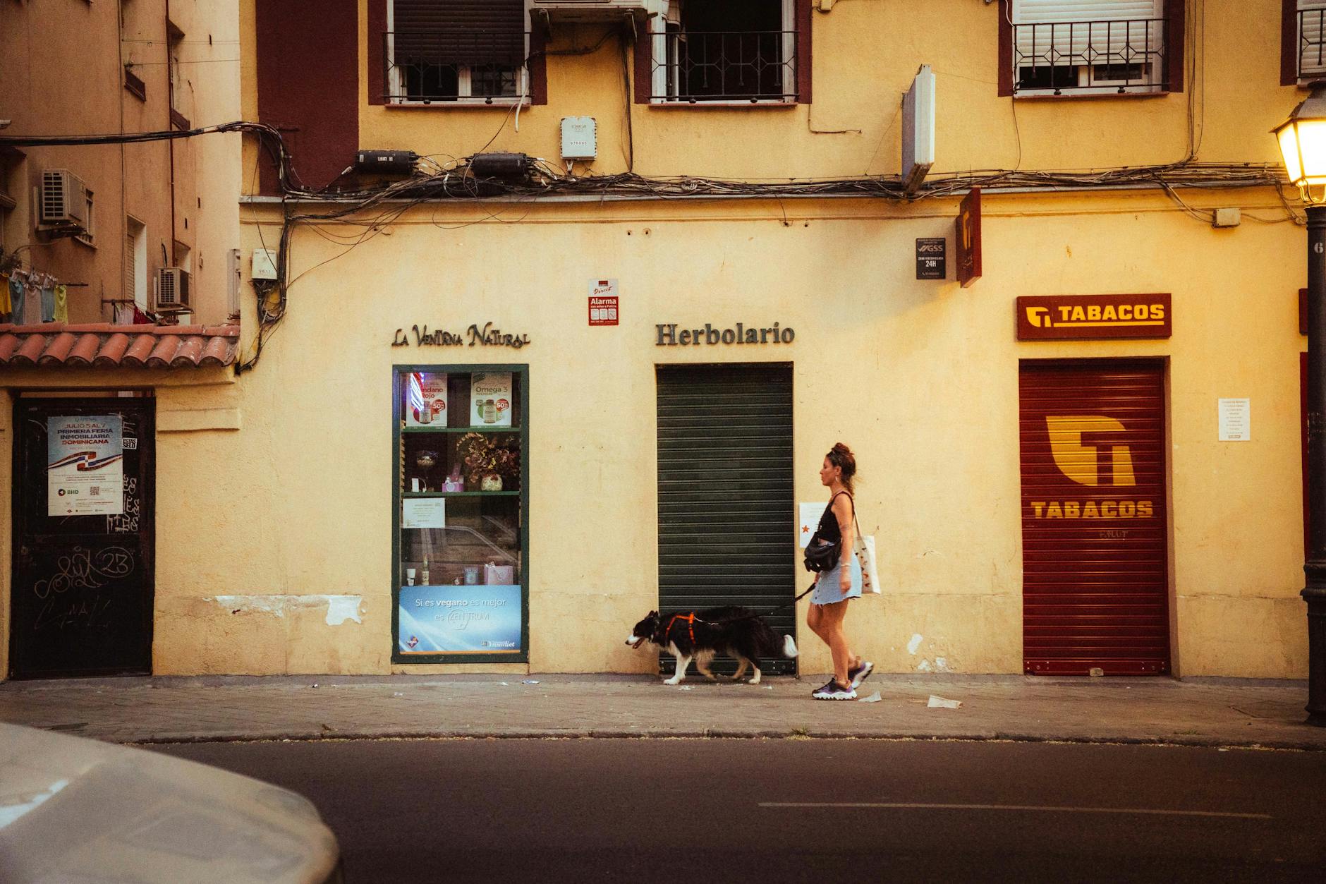 Woman walking past storefronts on a Madrid street