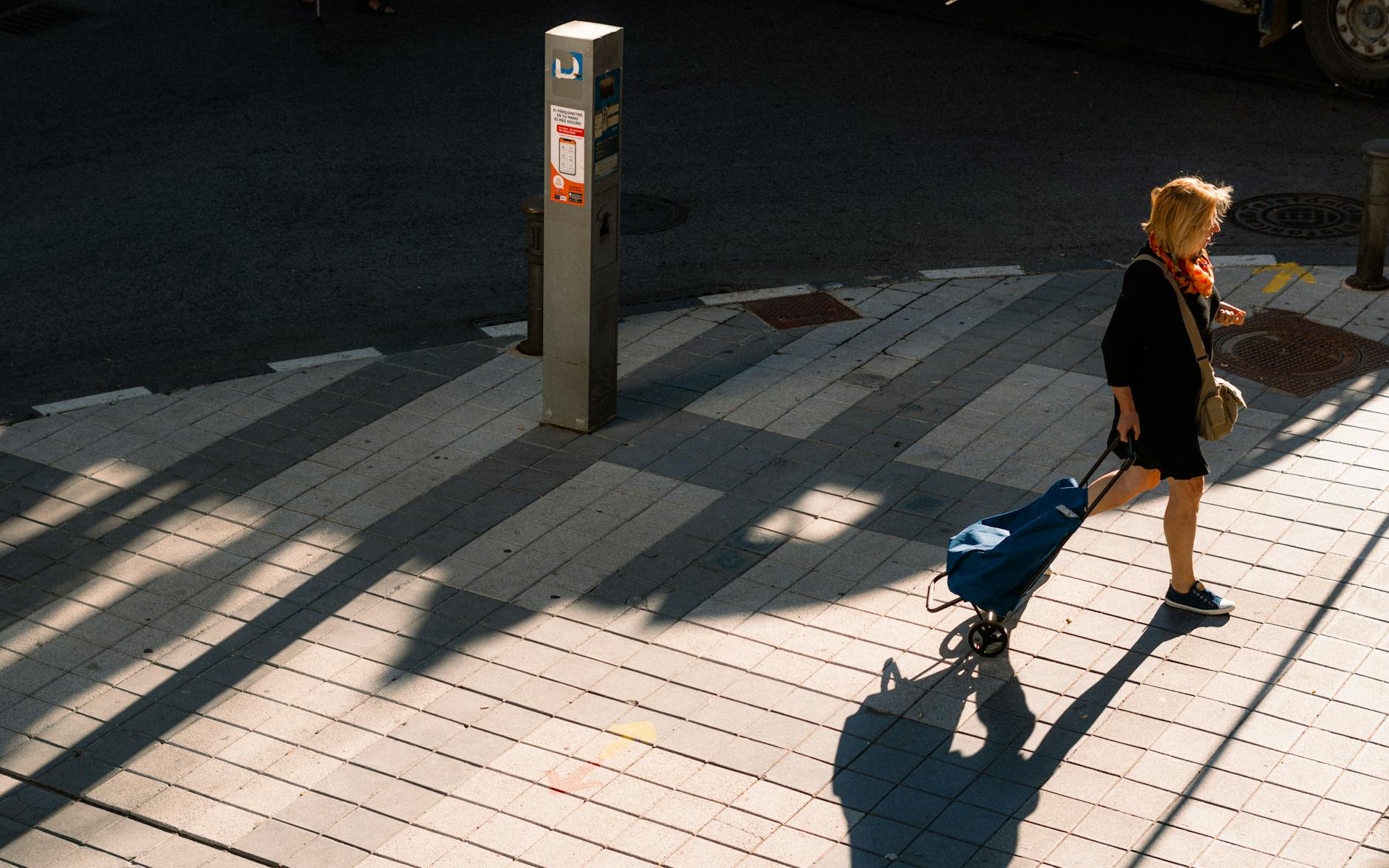 Woman walking on a Madrid street at sunset