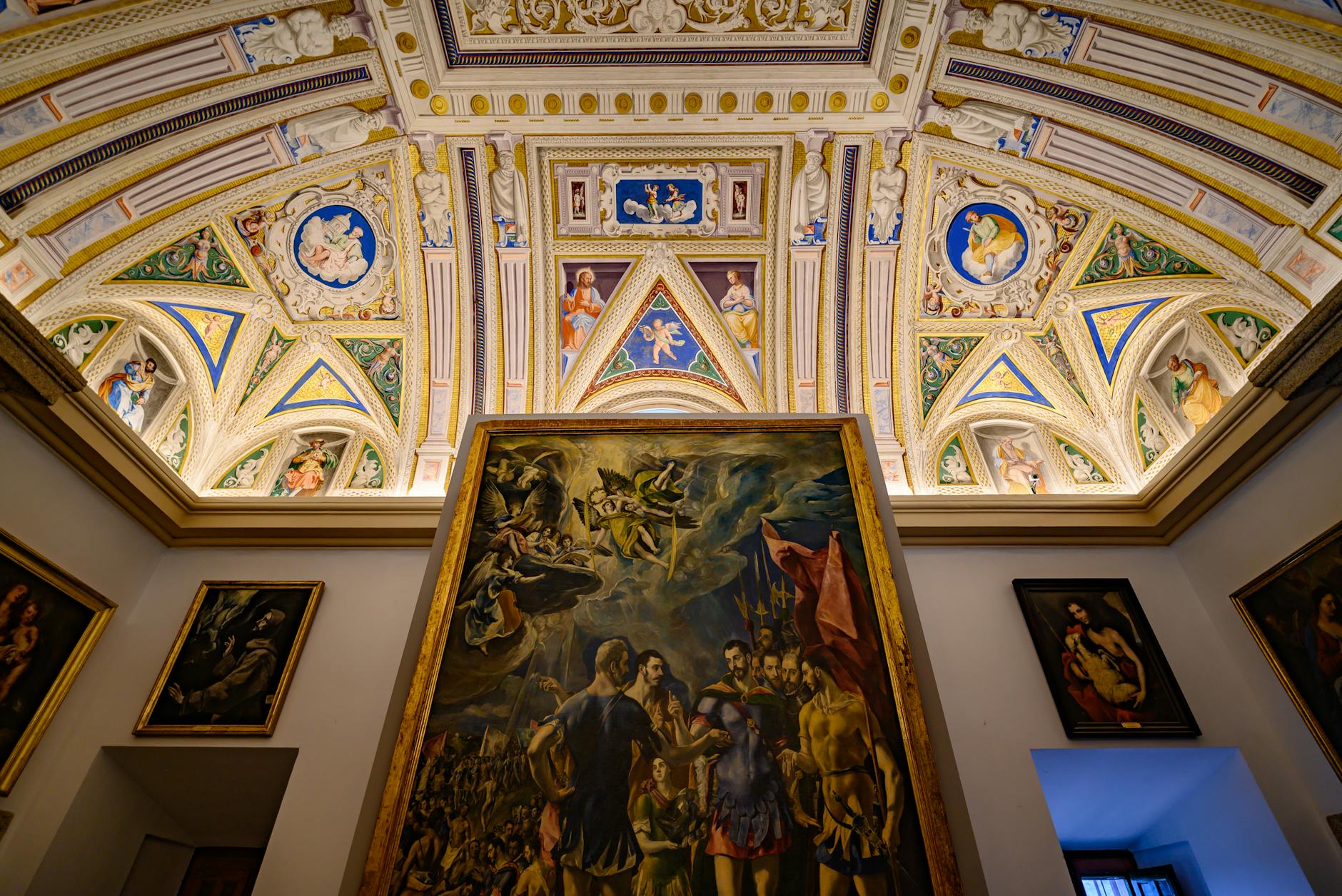 Ornate ceiling and classical paintings in a Madrid art museum