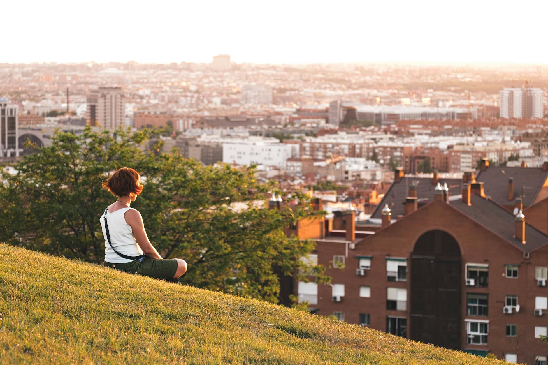 Woman looking over the Madrid skyline at sunset