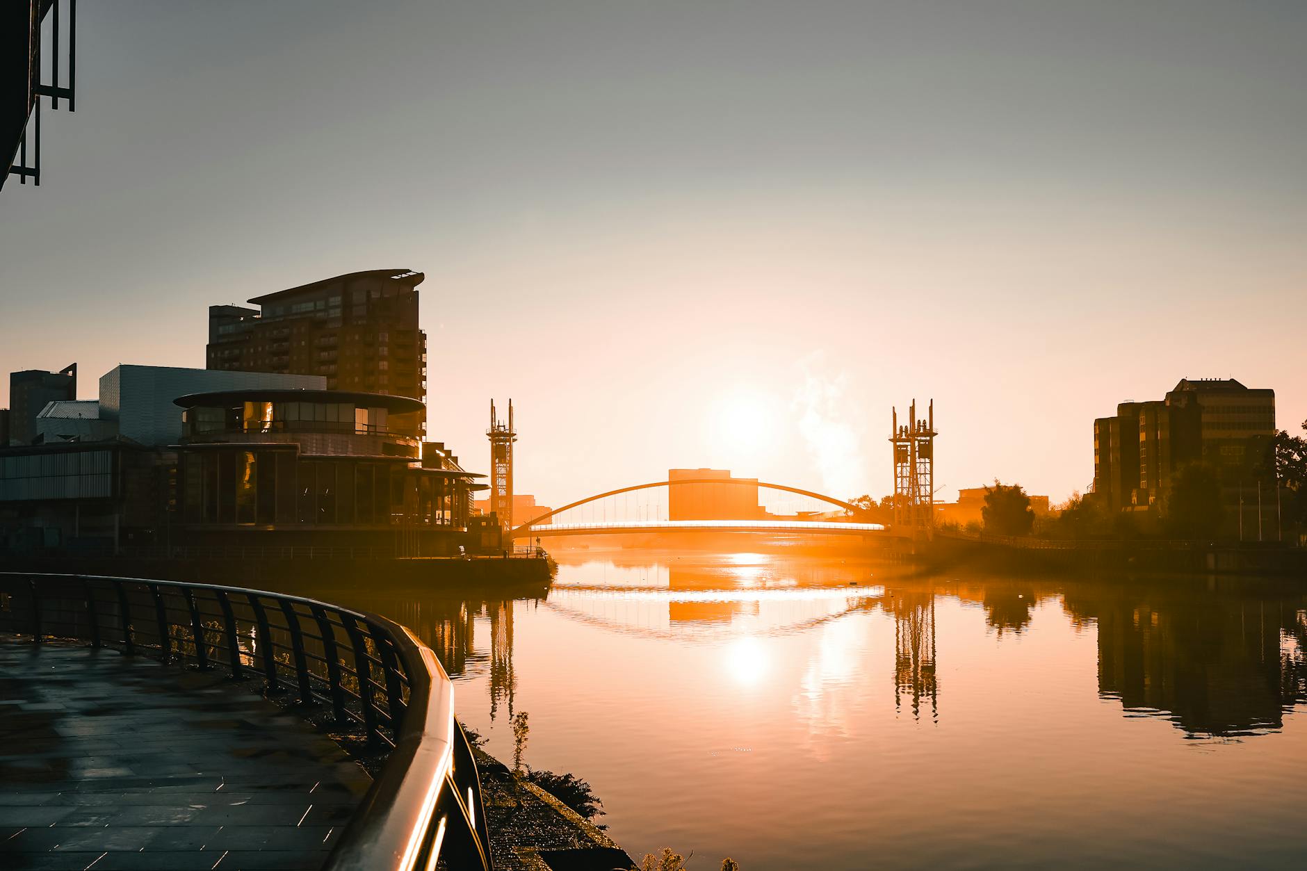 Sunrise over Salford Quays with modern architecture and water reflections