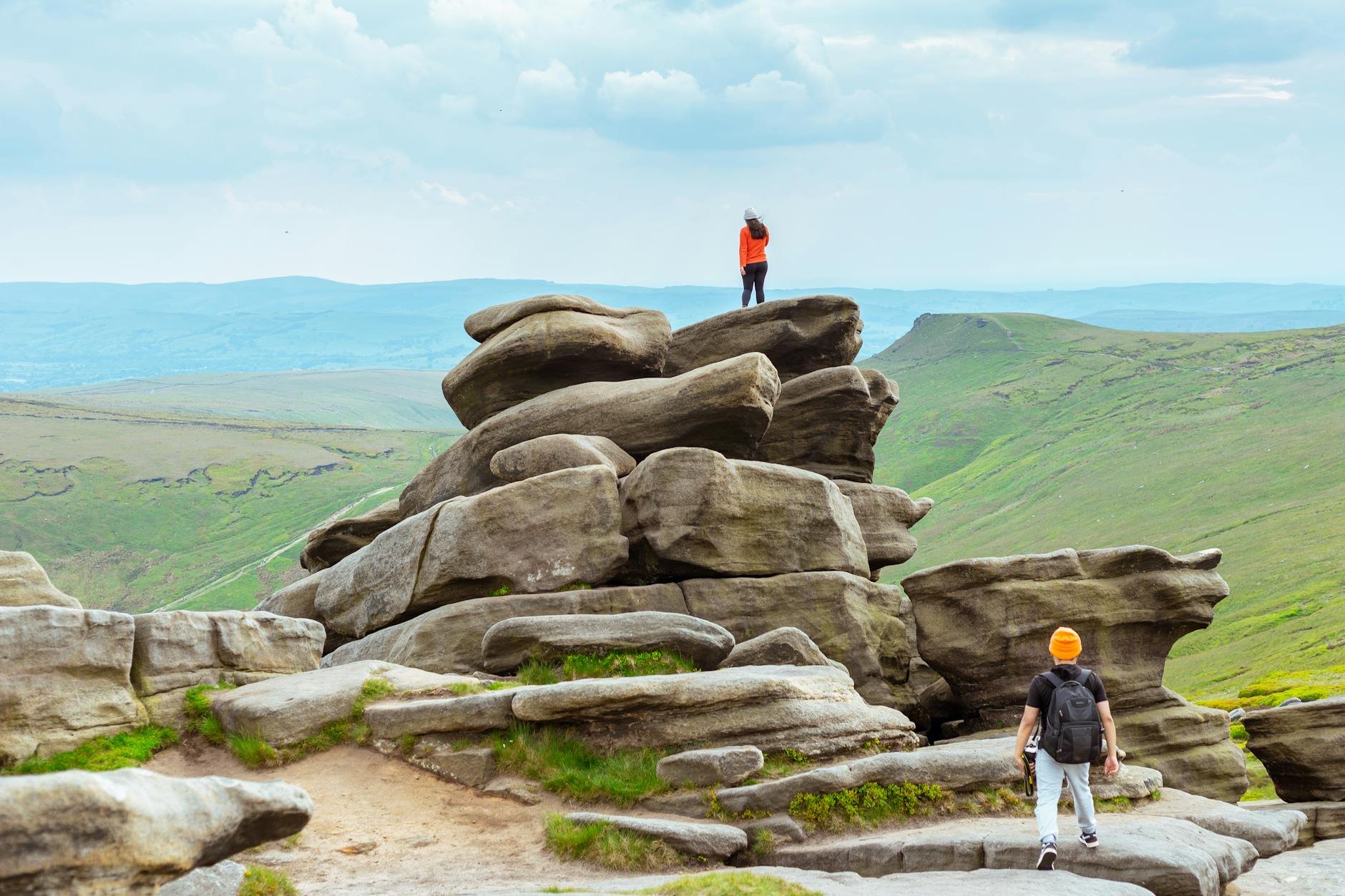 Hikers exploring rocky terrain on Kinder Scout