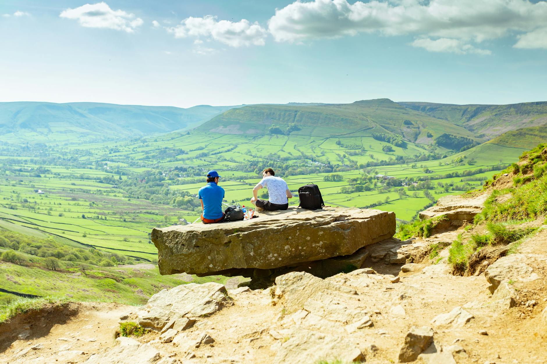 Hikers resting on rocks overlooking Hope Valley