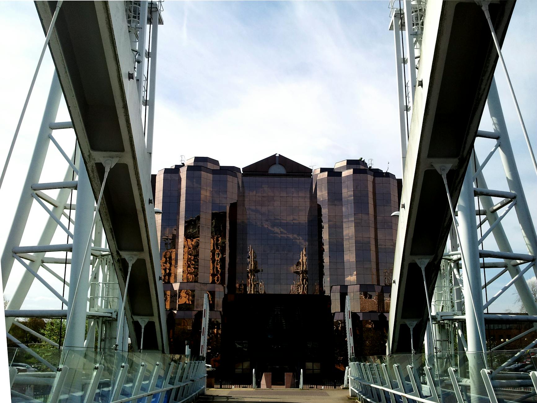 Reflective skyscraper and bridge in Manchester business district