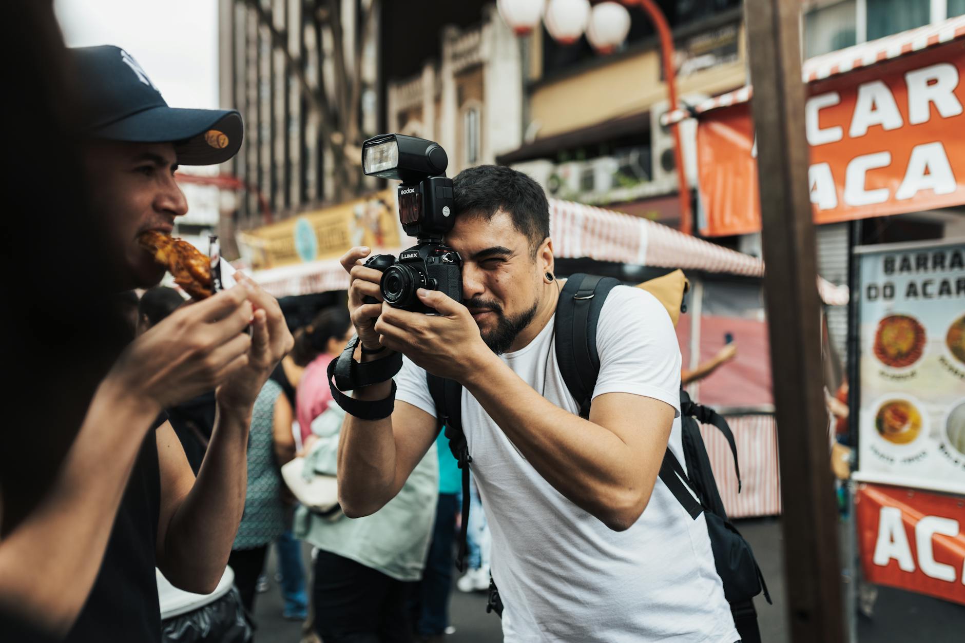 Street photographer capturing a lively market scene
