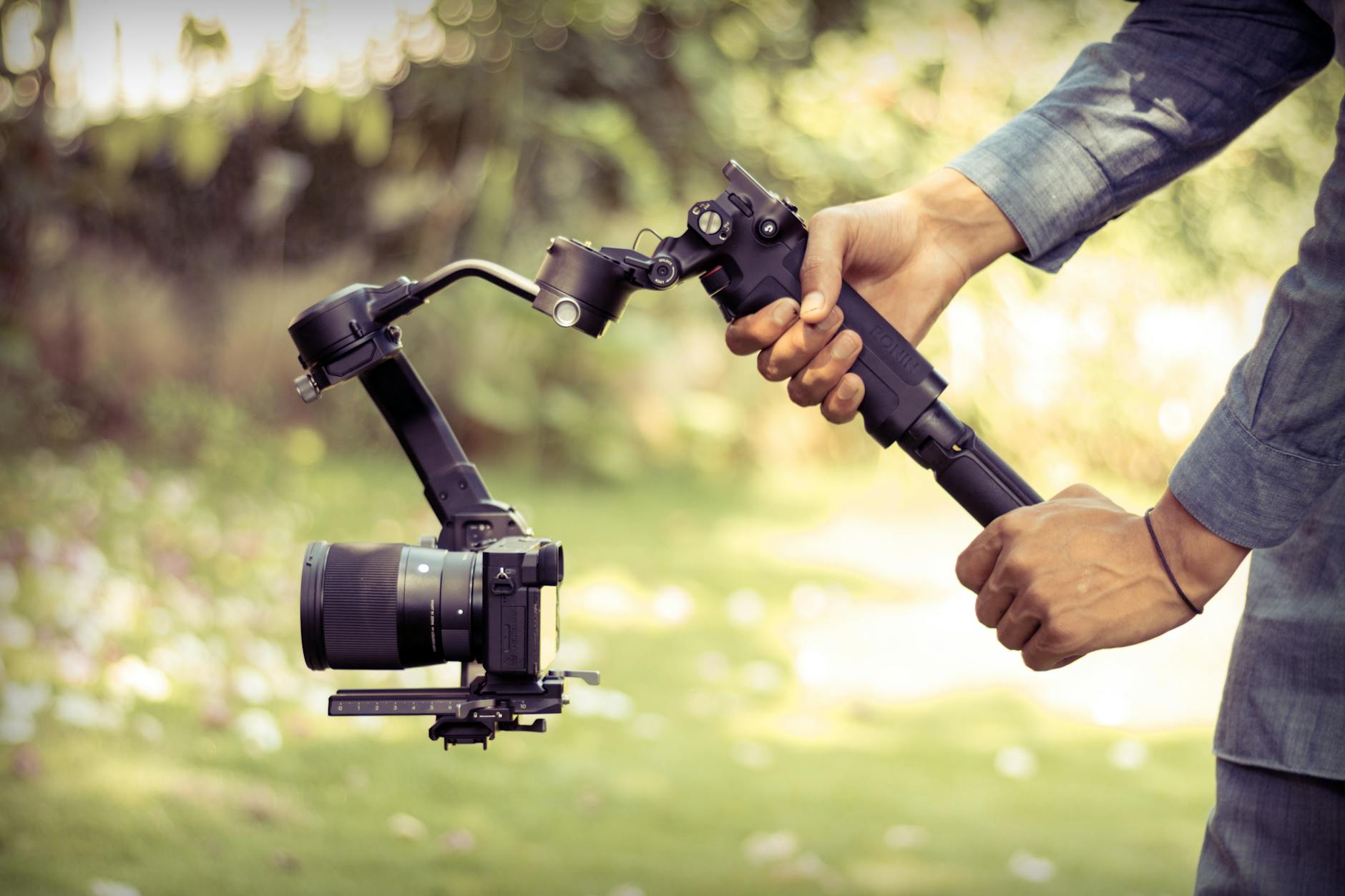Creator filming outdoors with a camera stabilizer