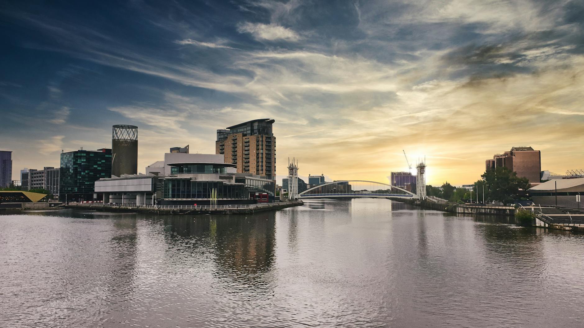 Salford Quays at sunset with modern architecture reflecting on the water