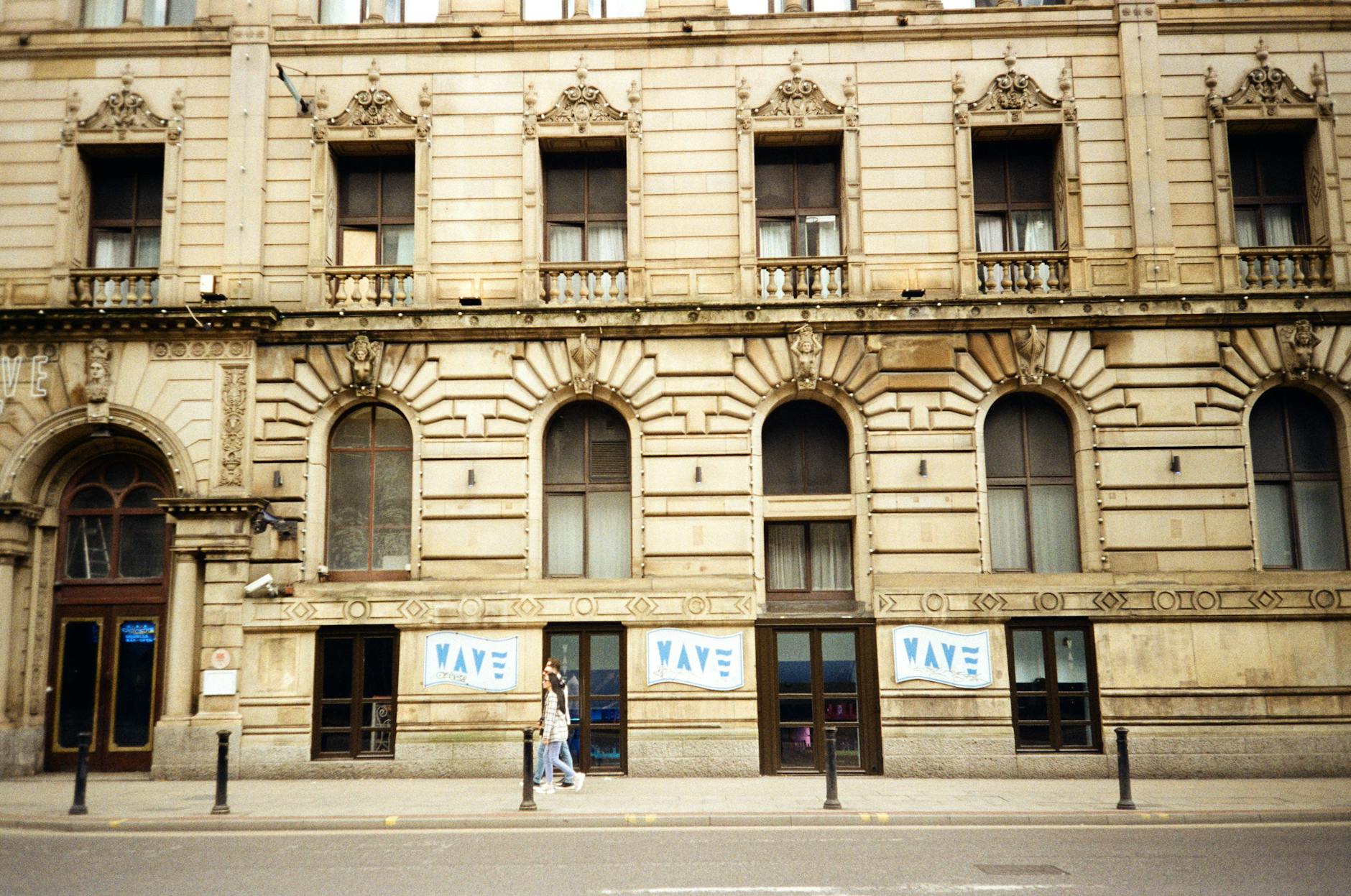 Historic Manchester building facade with a pedestrian passing by