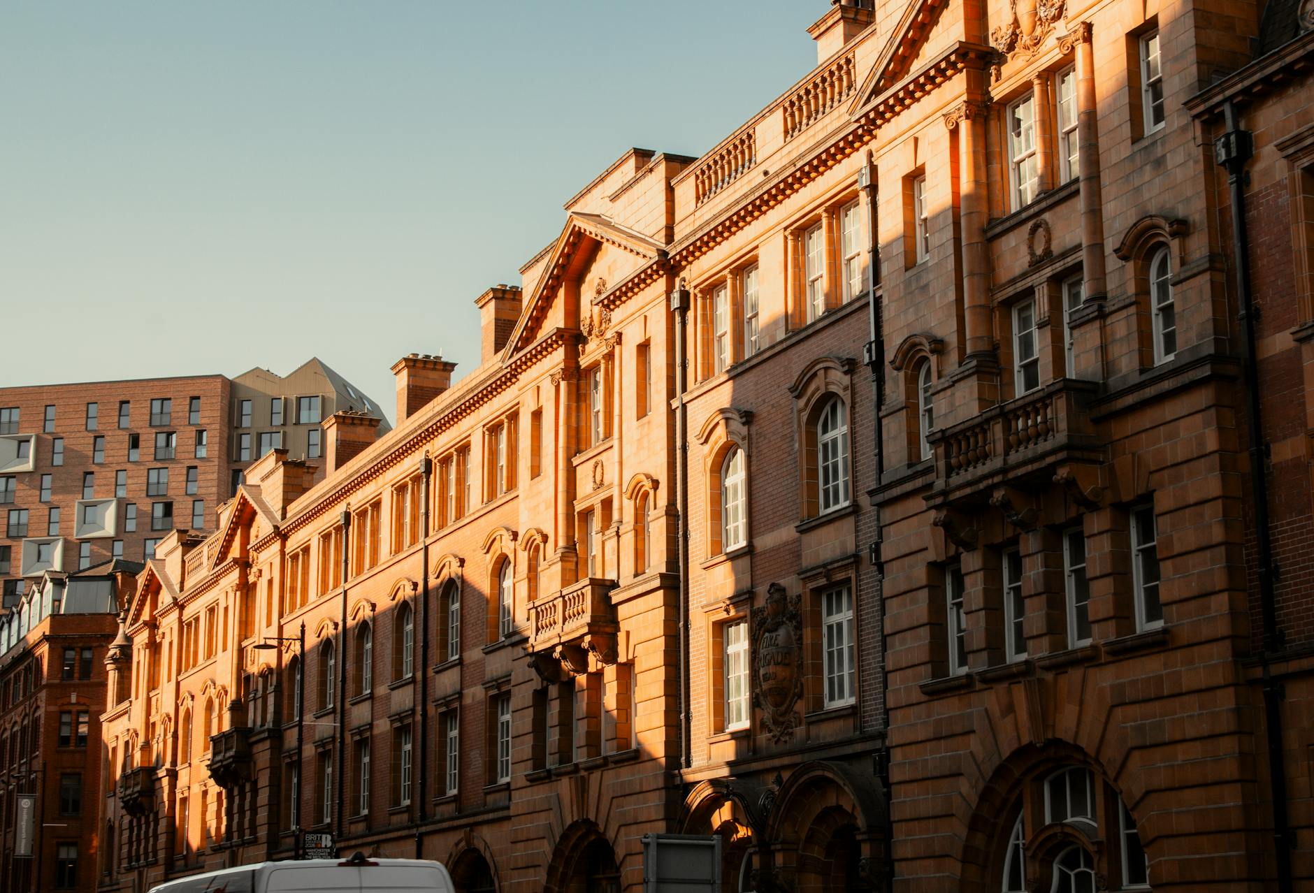 Historic Manchester buildings lit by sunset