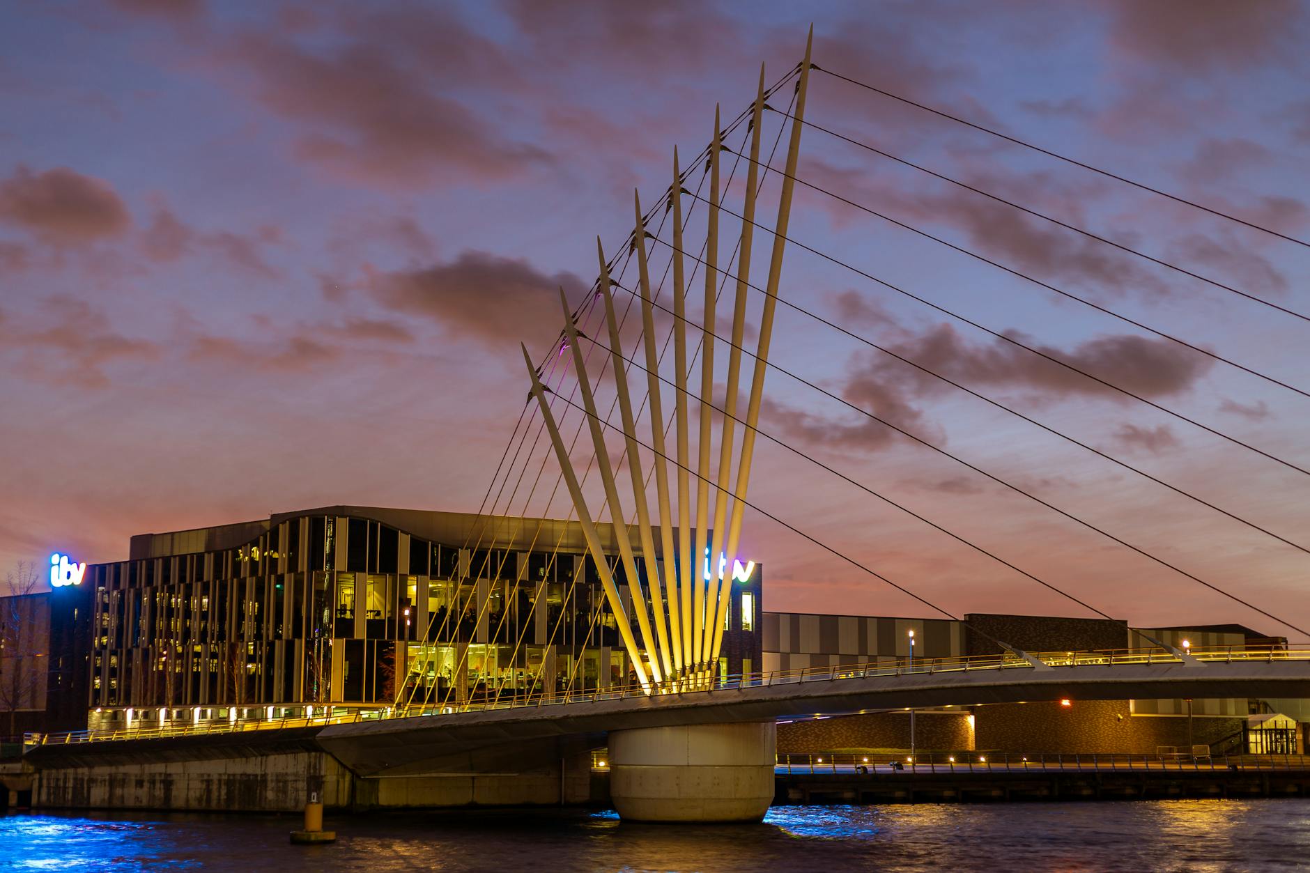 Evening footbridge and waterfront lights at Salford Quays