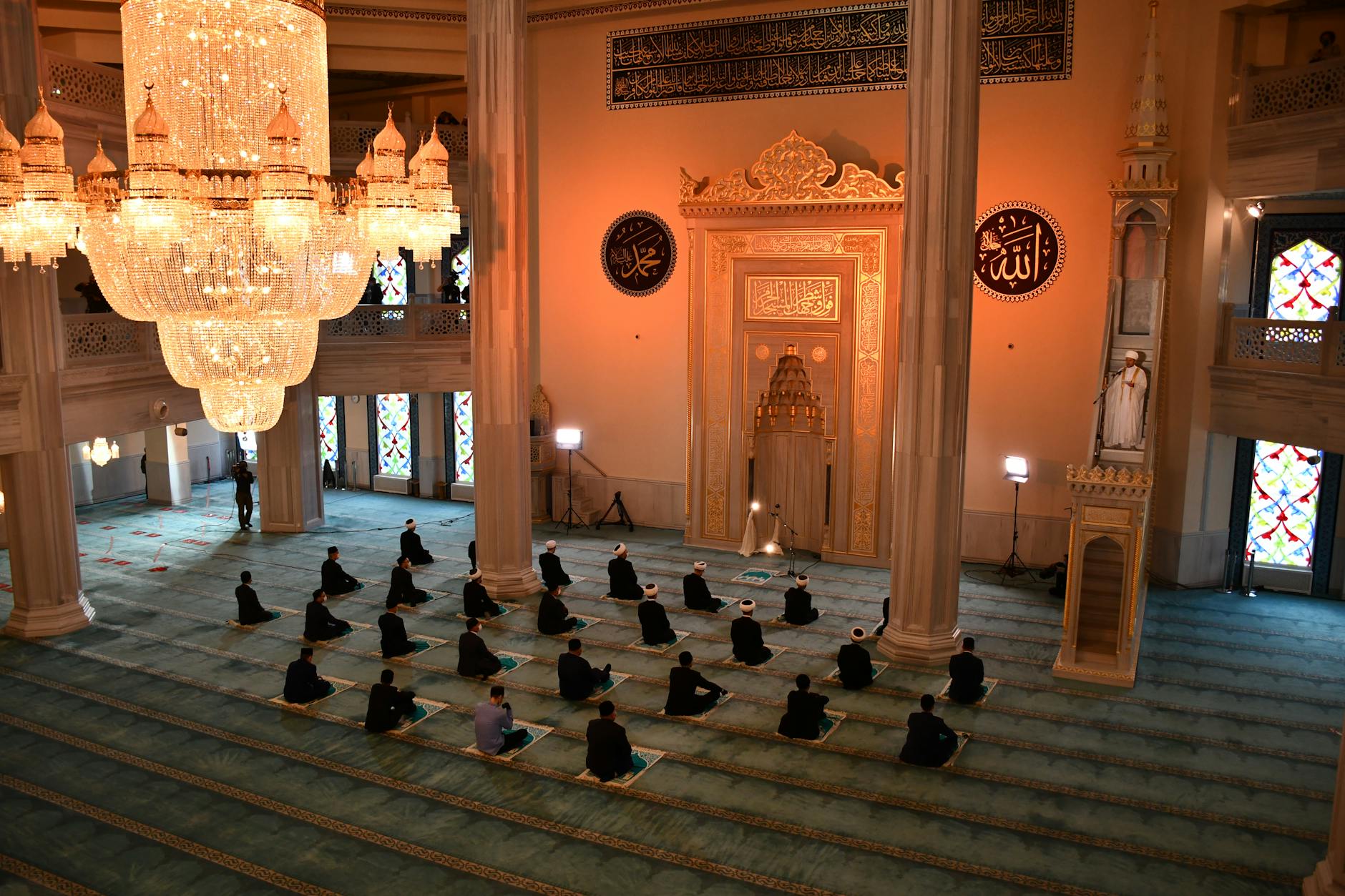 Worshippers praying inside a mosque interior