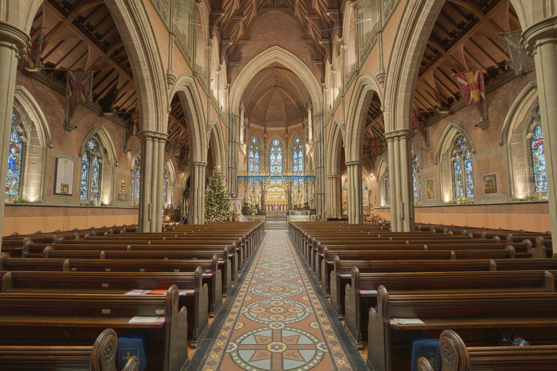 Historic Gothic church interior with arches and stained glass