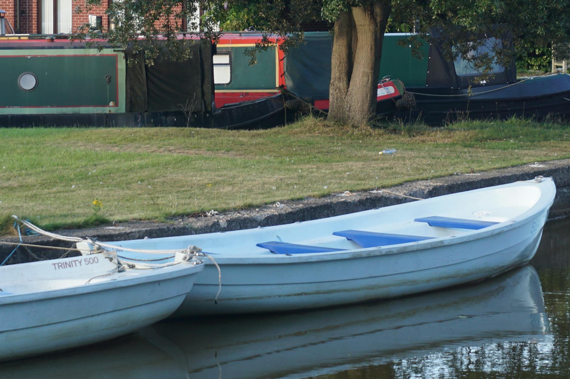 Canal boats moored along a quiet canal in Eccles