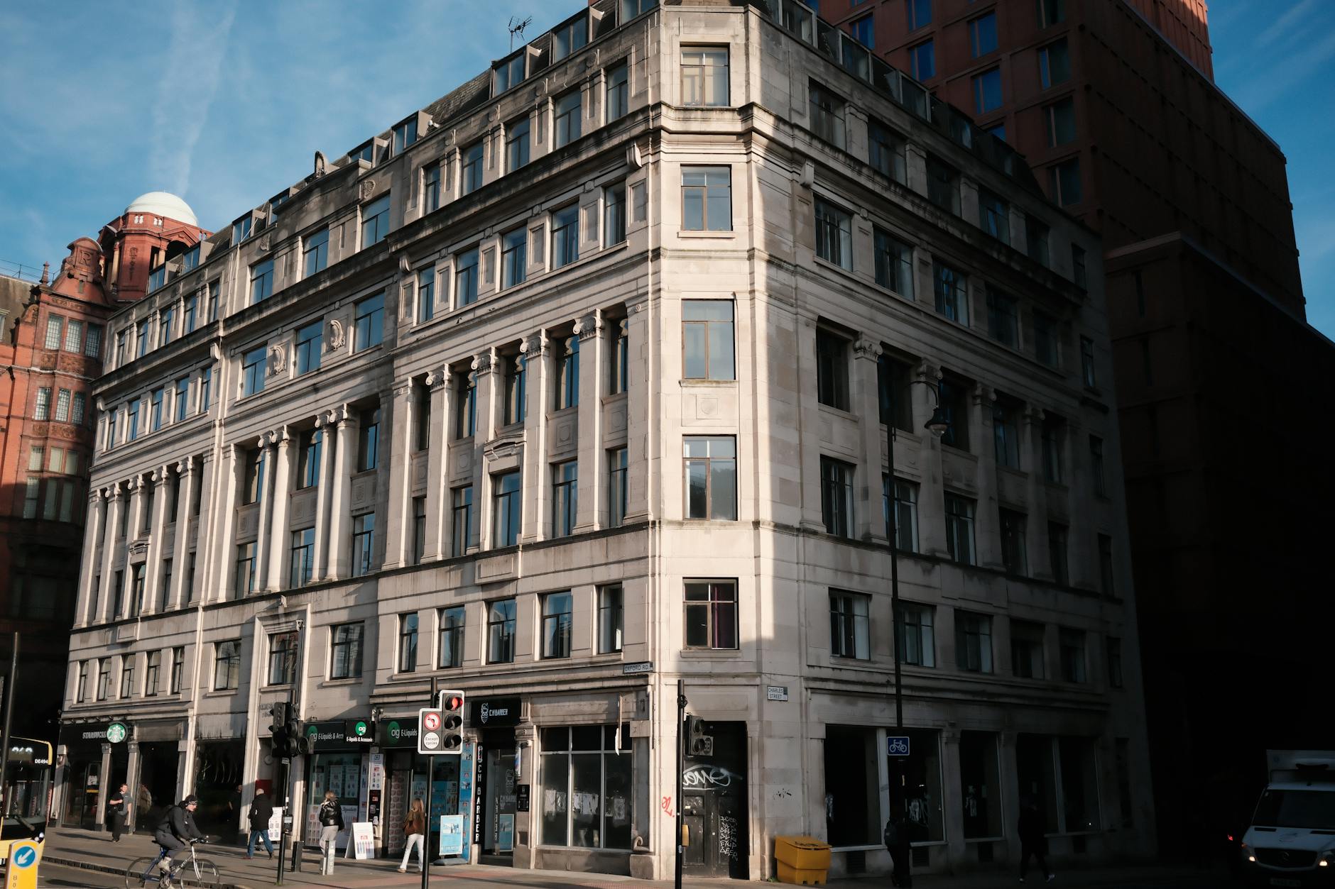 Historic Manchester building on a sunny city street corner