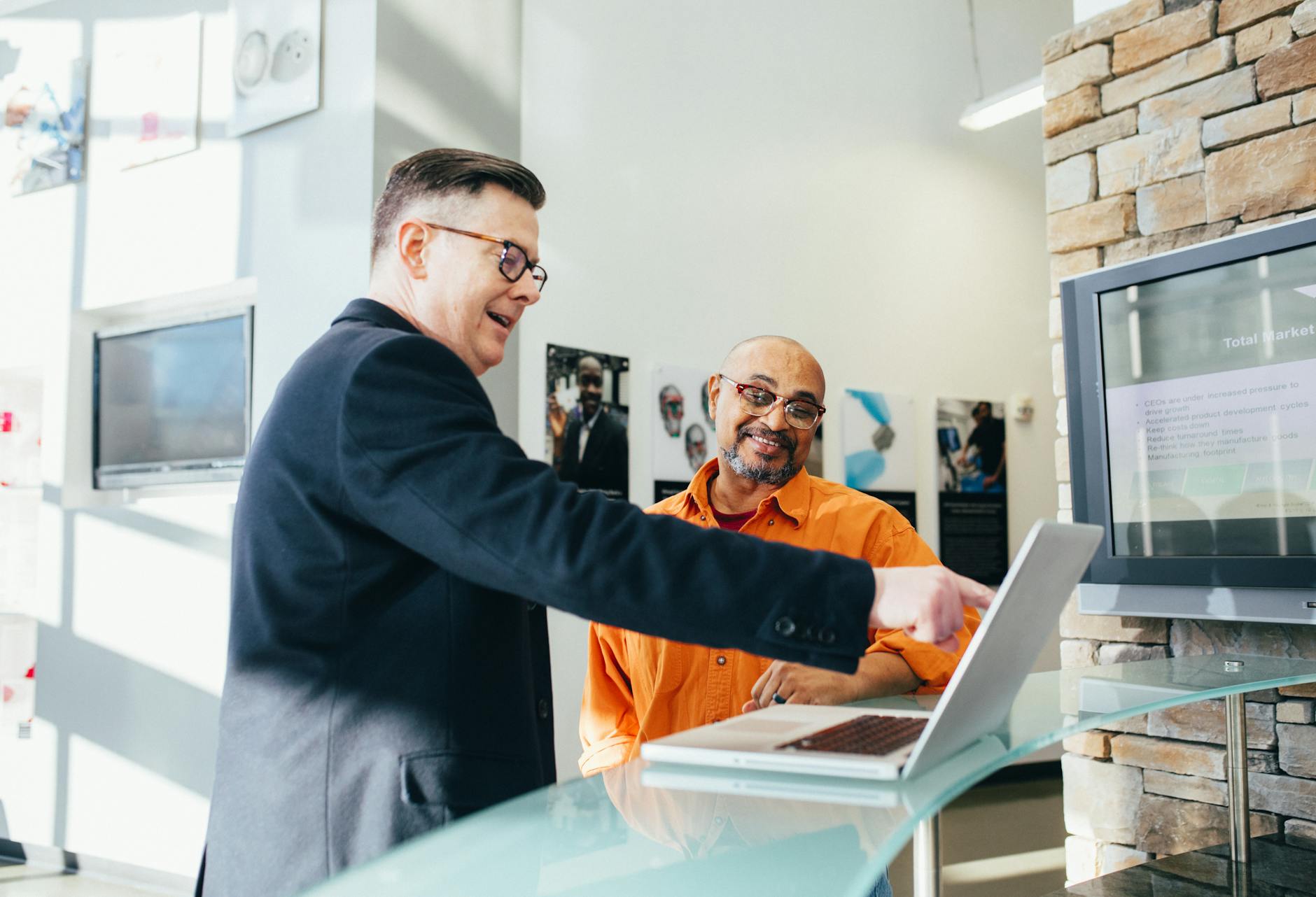 Two business professionals discussing a laptop presentation