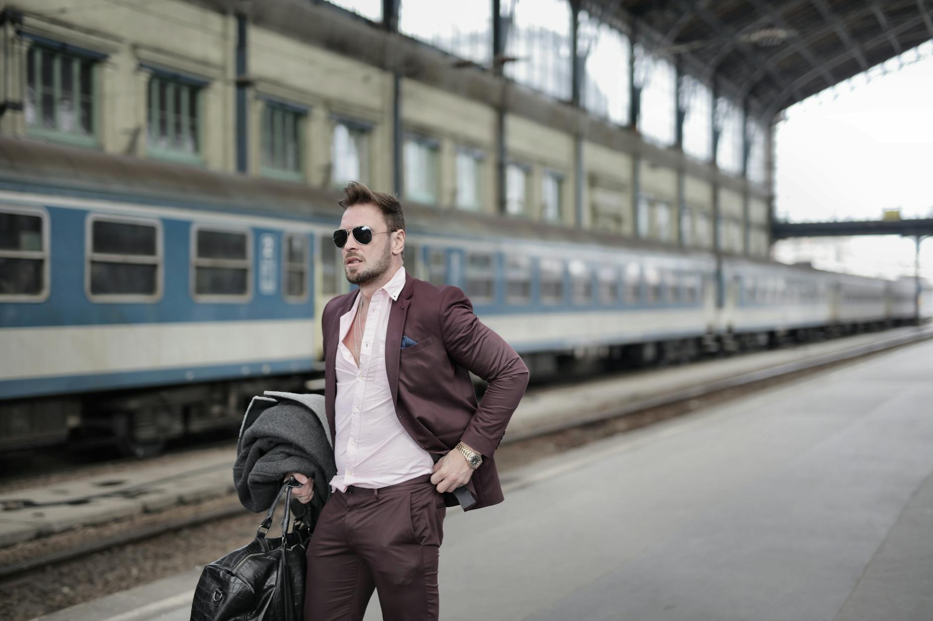 Business traveler with bag waiting on a railway platform