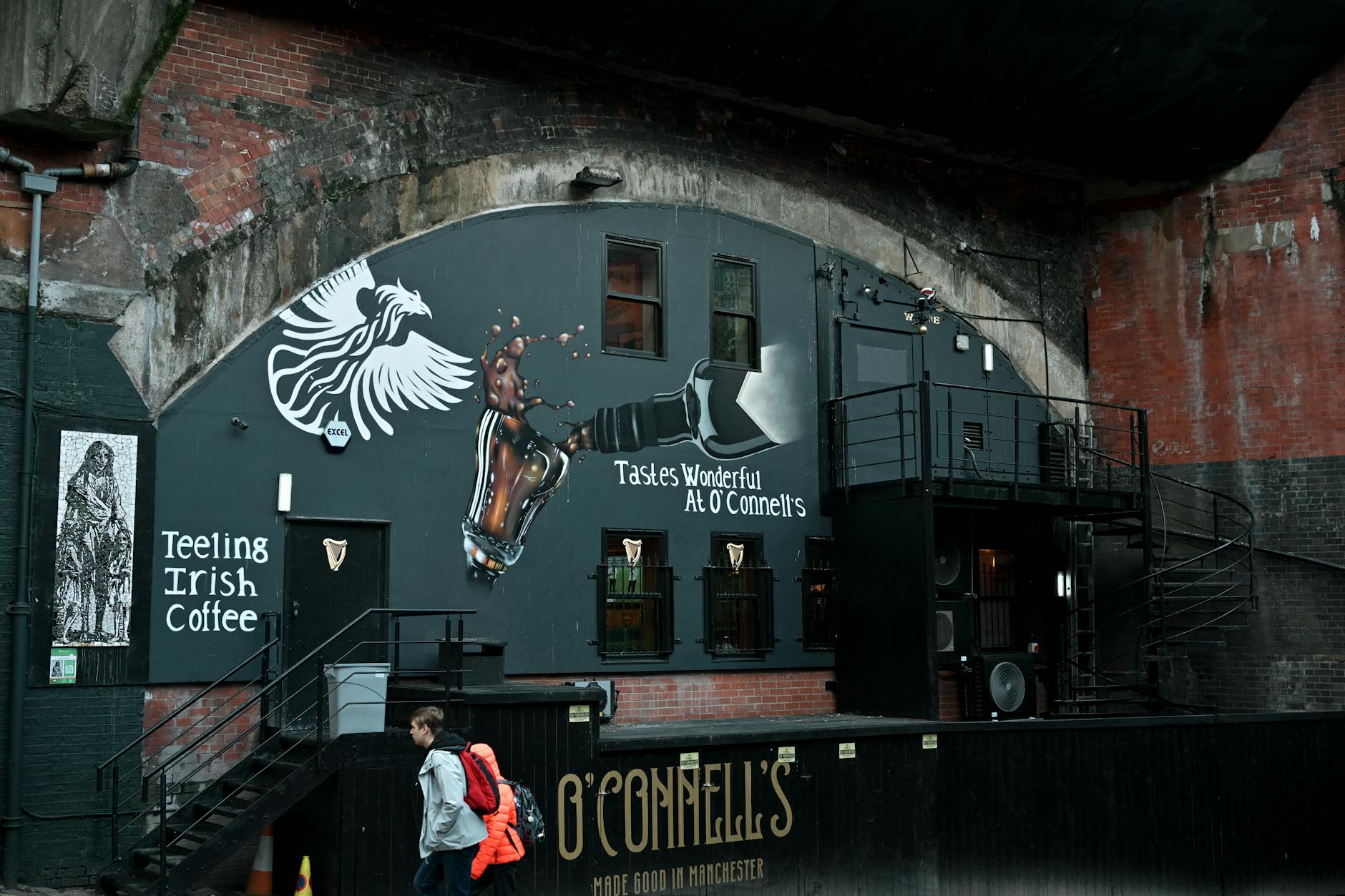 Manchester urban alley with a coffee-themed street art mural