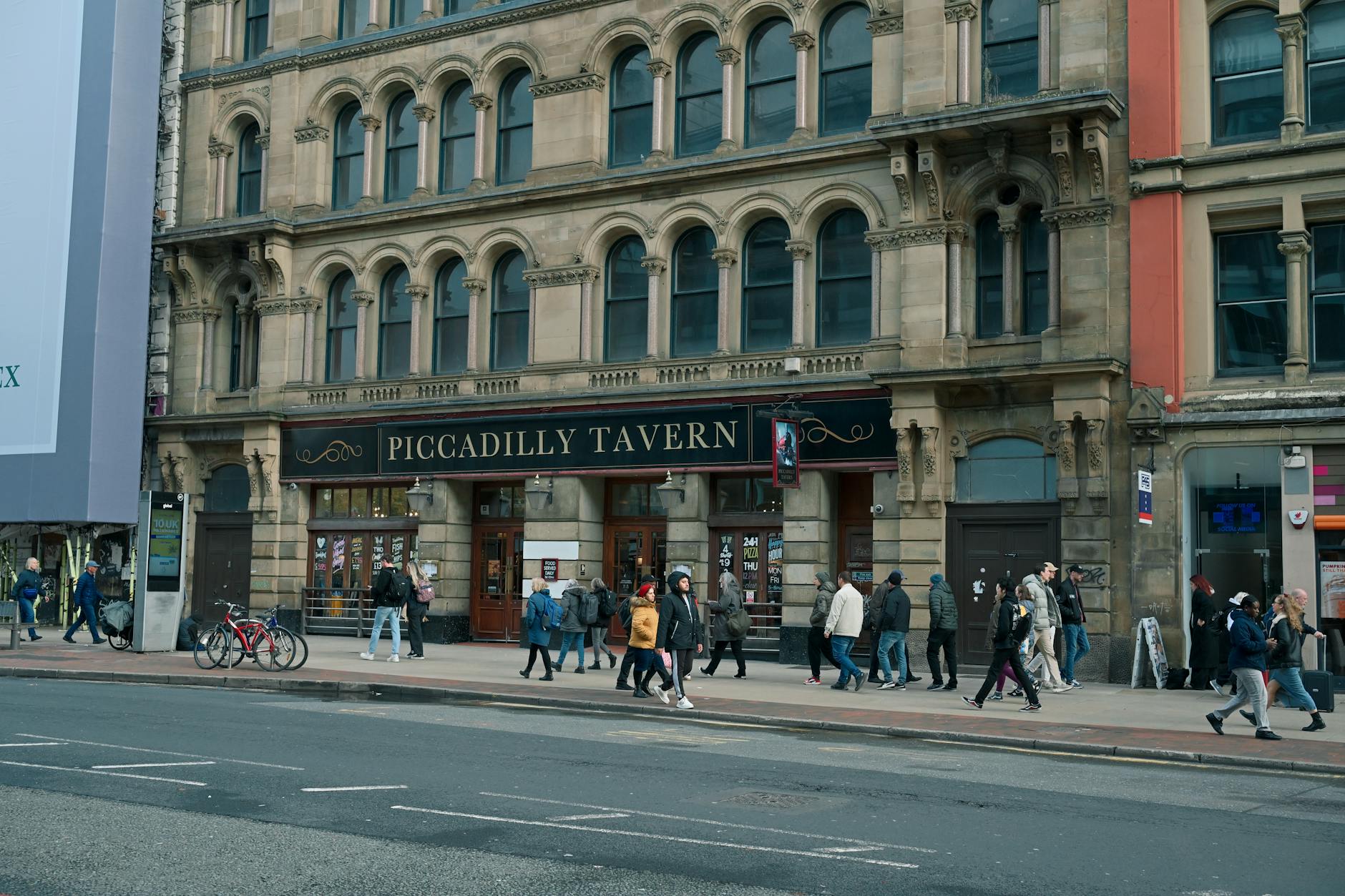 People walking near the Piccadilly Tavern in Manchester city centre