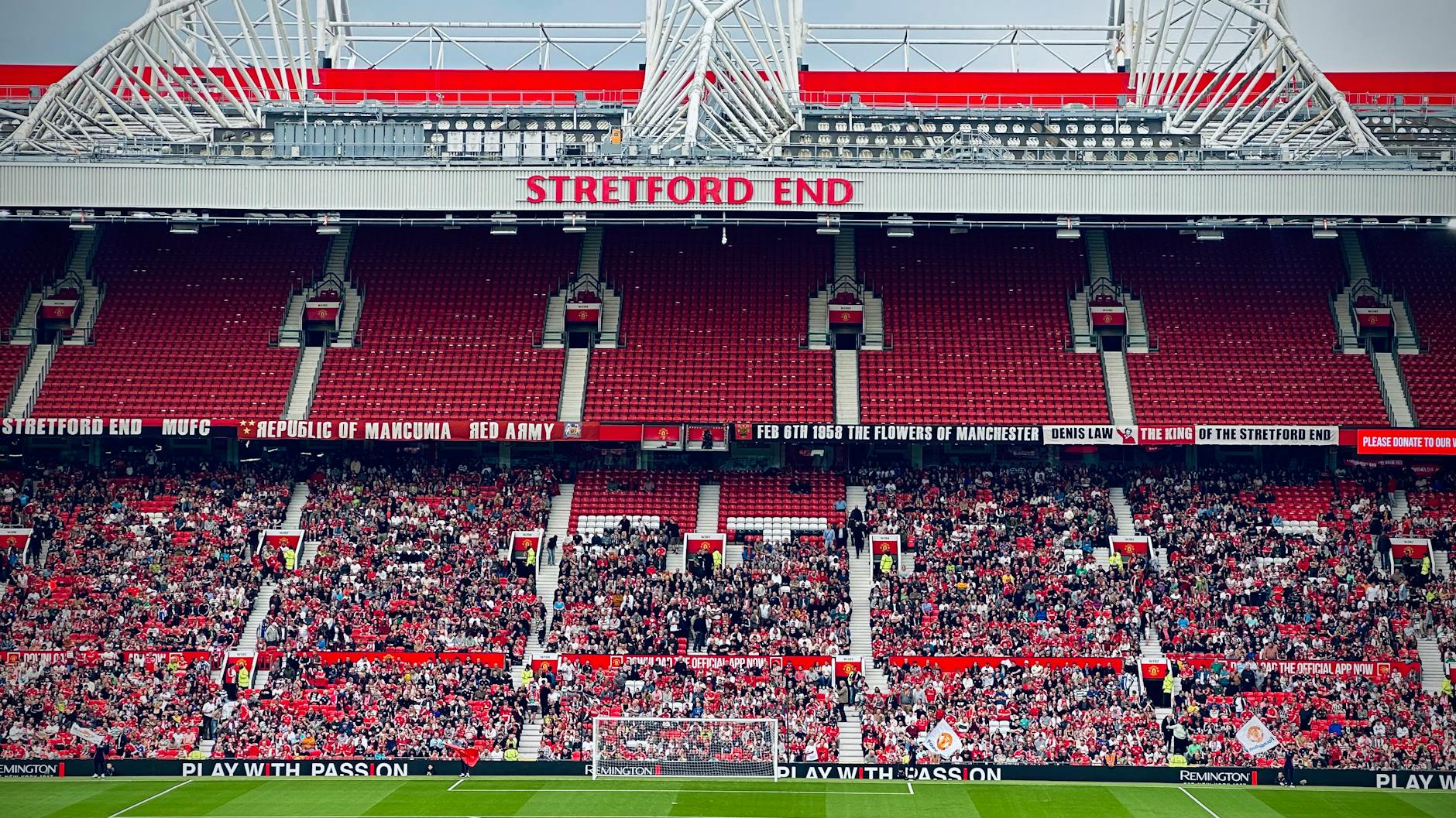 Crowd gathered at a Manchester football stadium during a day event