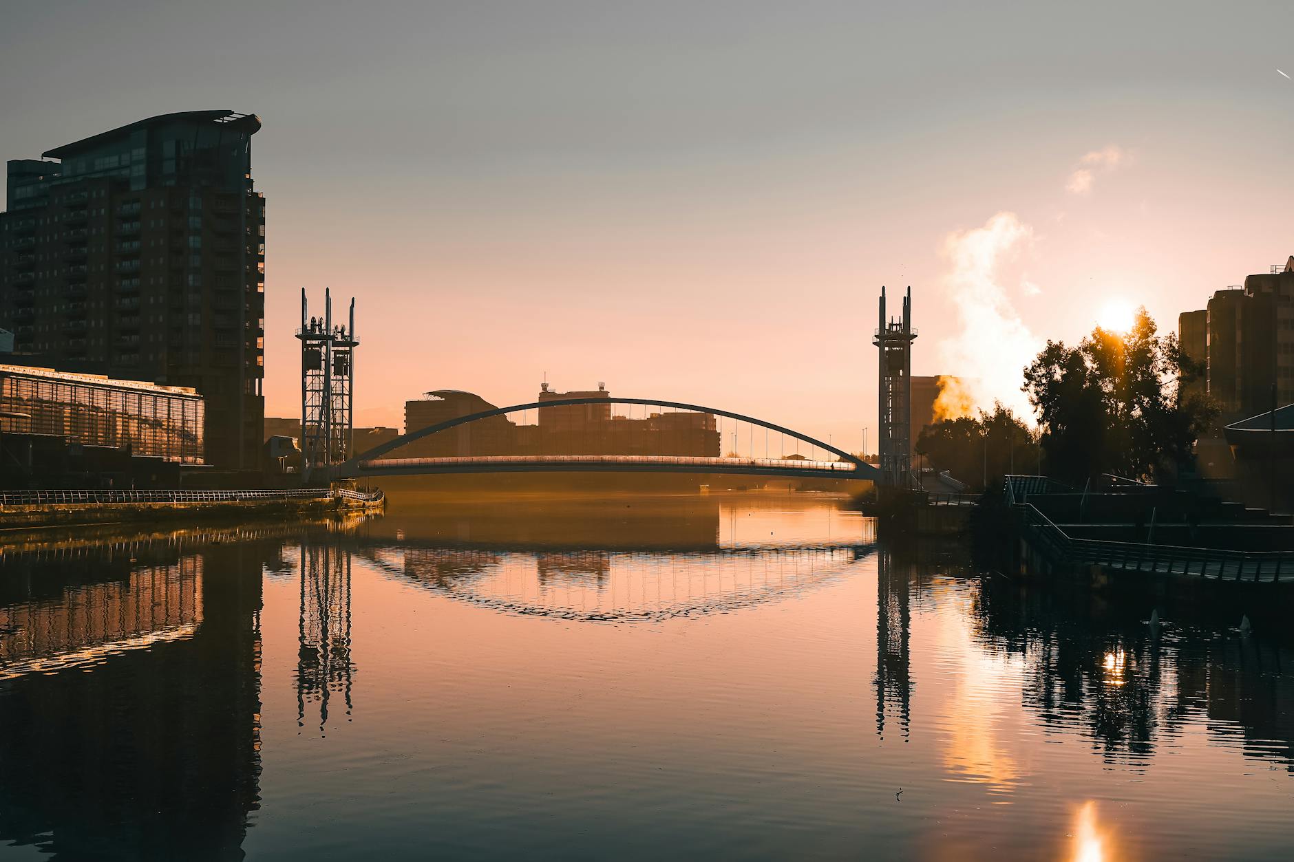 Salford Quays at golden hour with reflections on the water