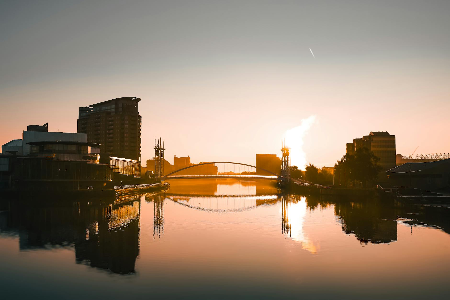 Salford Quays sunset with modern architecture reflected in the water