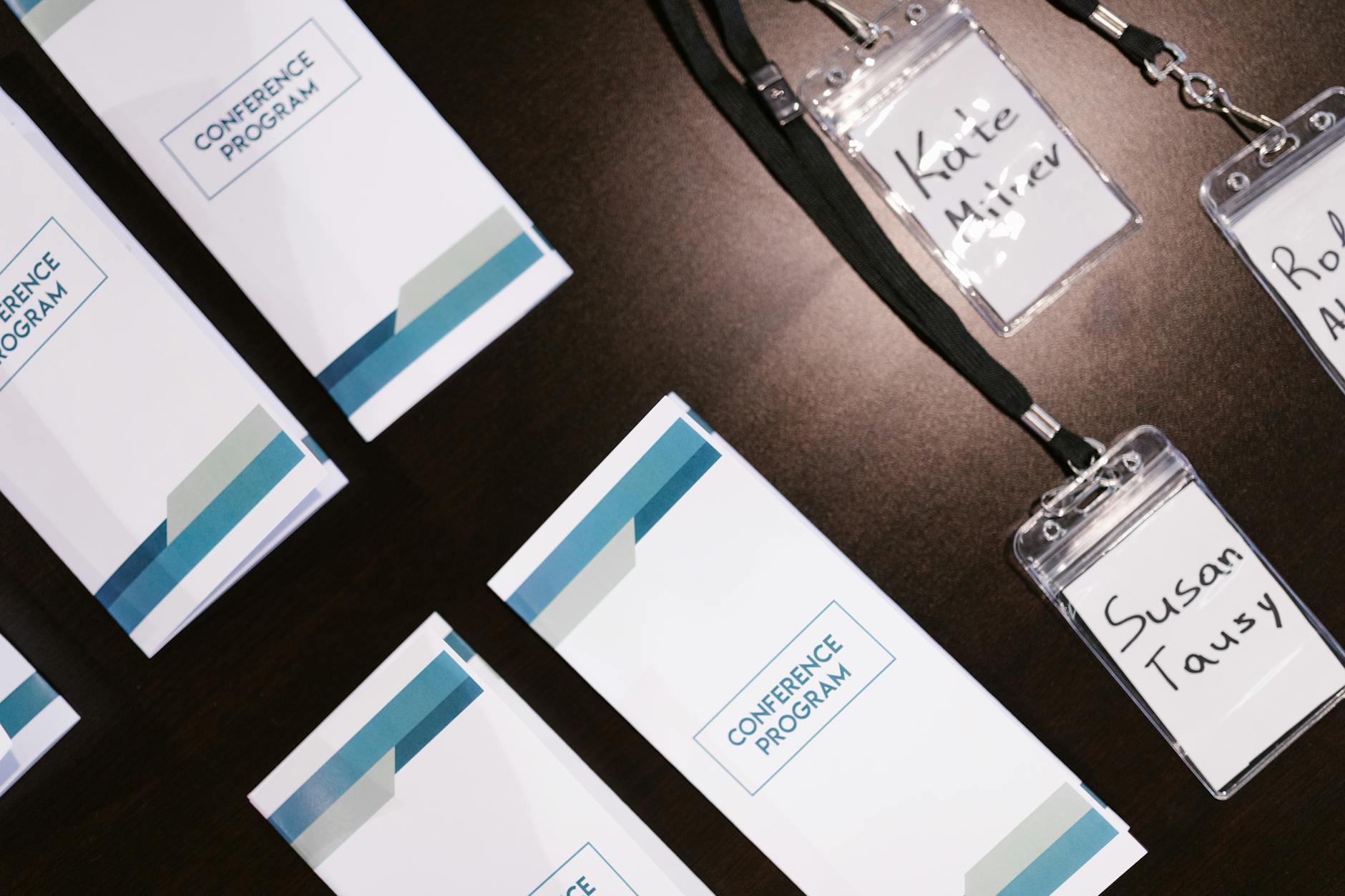 Conference programs and name badges arranged on a table