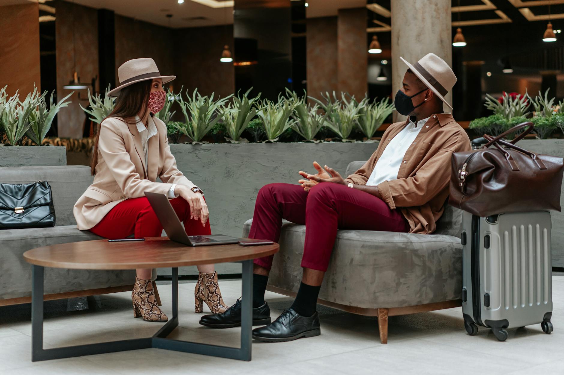 Business travelers meeting in a hotel lobby