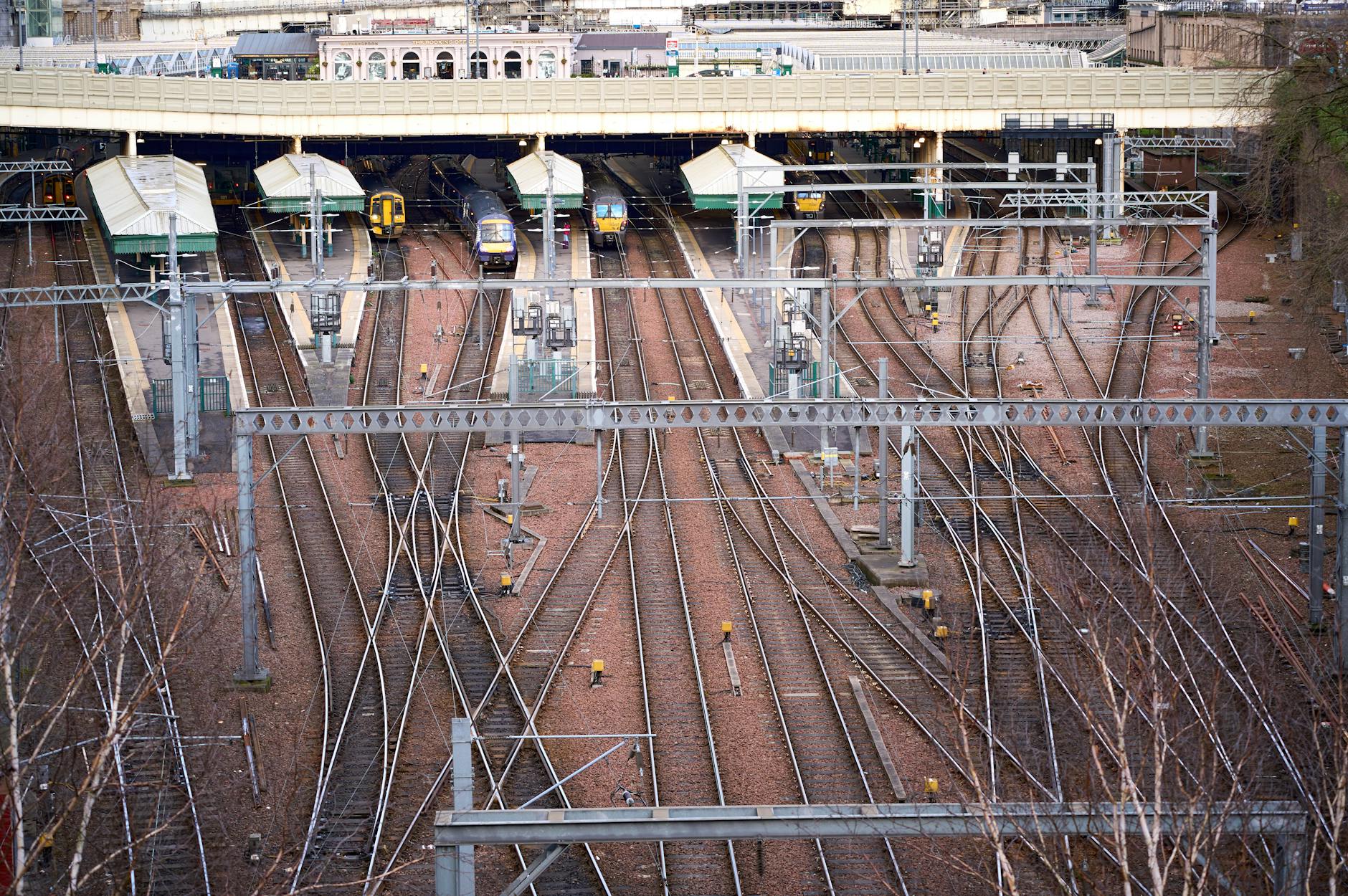 Railway tracks leading into a busy station hub
