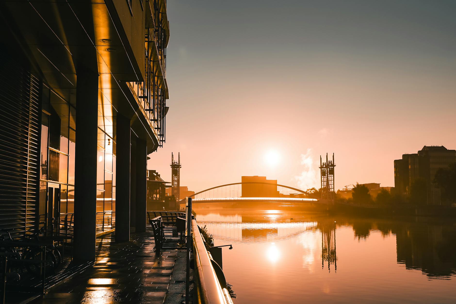 Salford Quays sunrise with reflective water and modern Manchester architecture