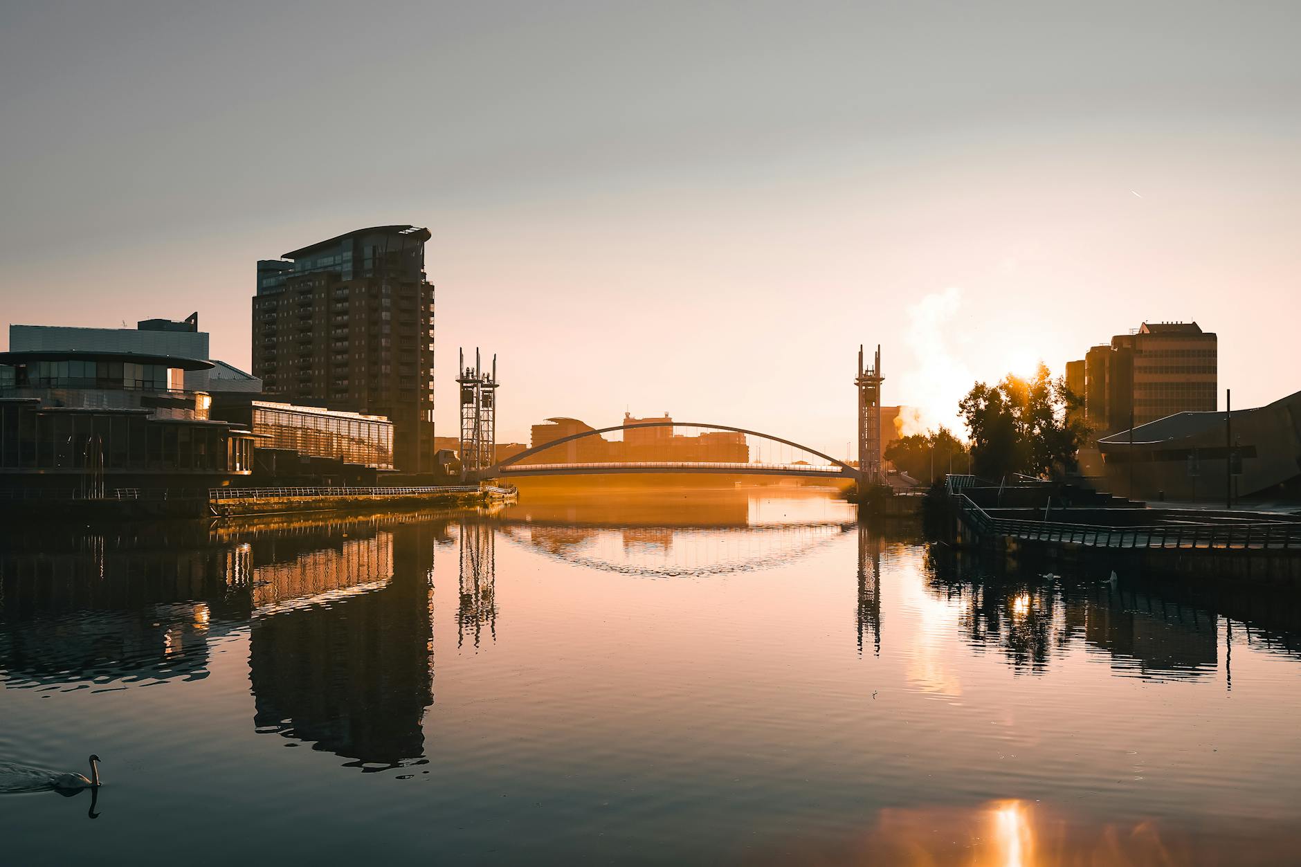Salford Quays sunset with calm water and Manchester waterfront buildings