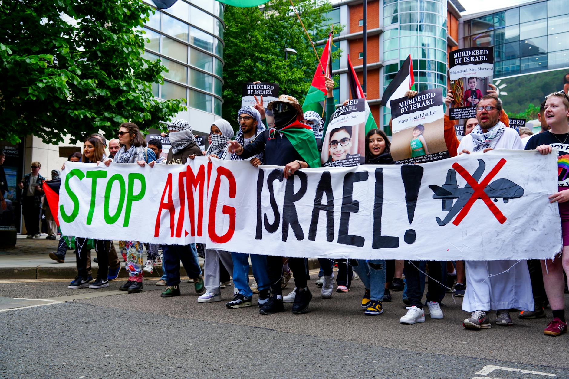 Manchester street protest with banners and a crowd
