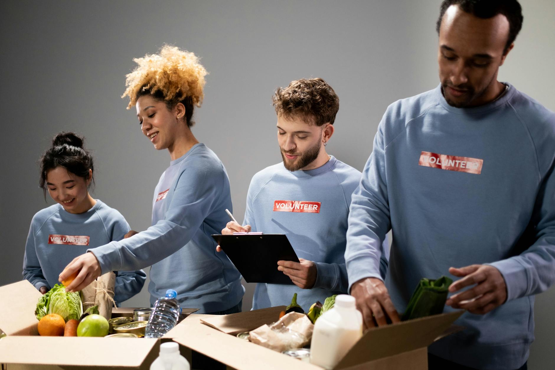 Volunteers packing food donations together indoors