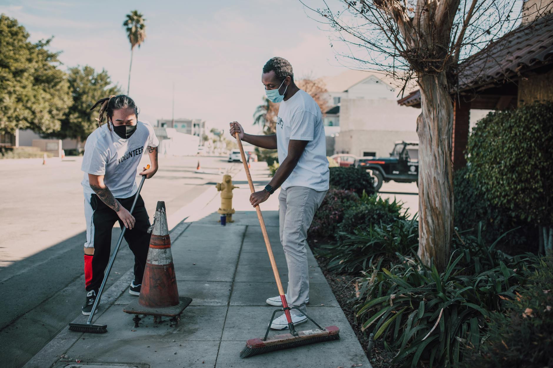 Volunteers cleaning a city sidewalk during community service