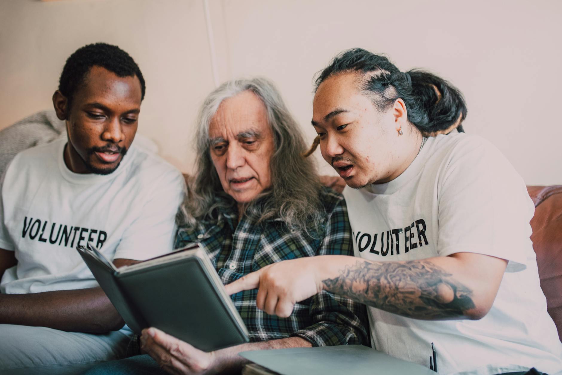 Volunteers assisting an older adult during a community support visit