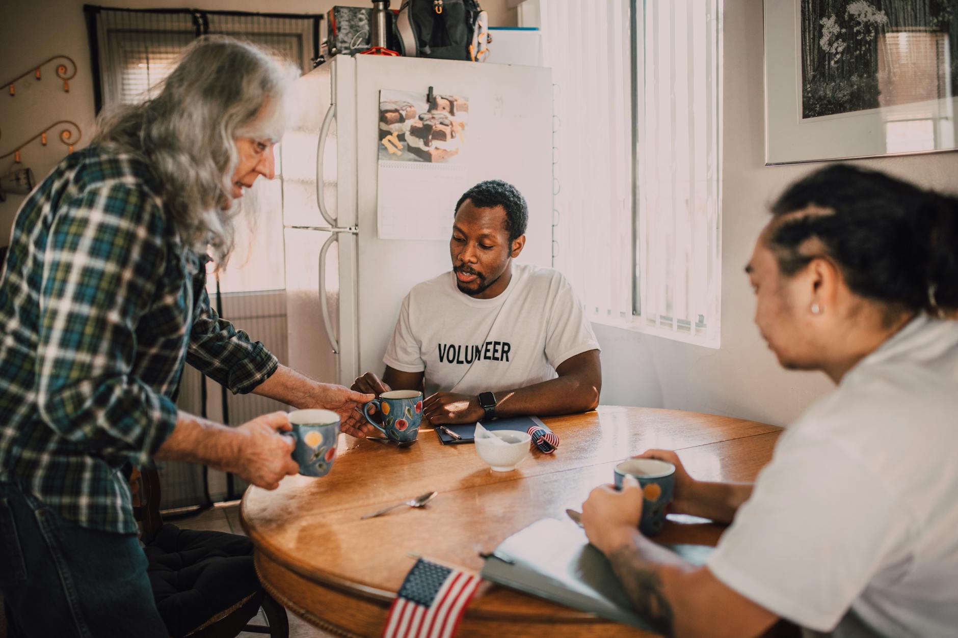 Volunteers sharing coffee and notes during a team debrief