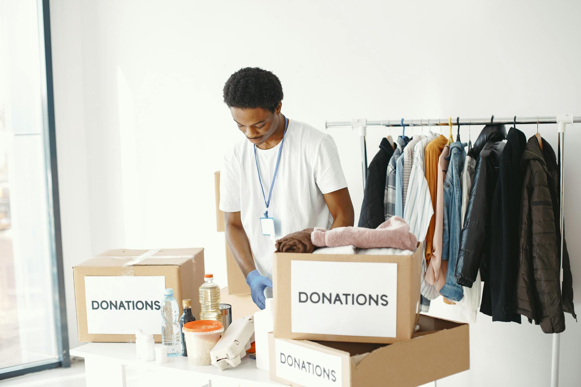 Volunteer organizing donation boxes in a community center