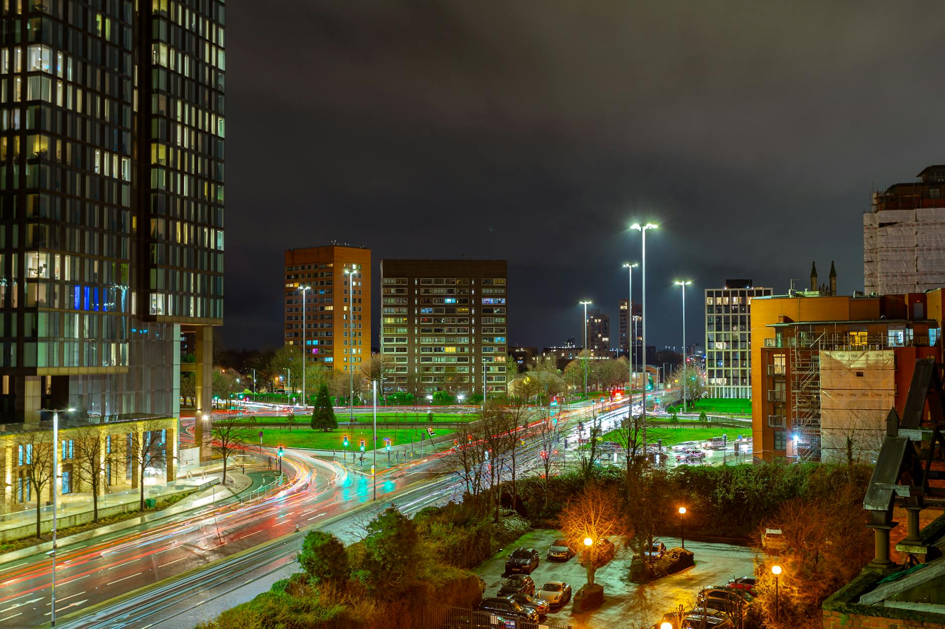 Manchester illuminated at night with city buildings and streets