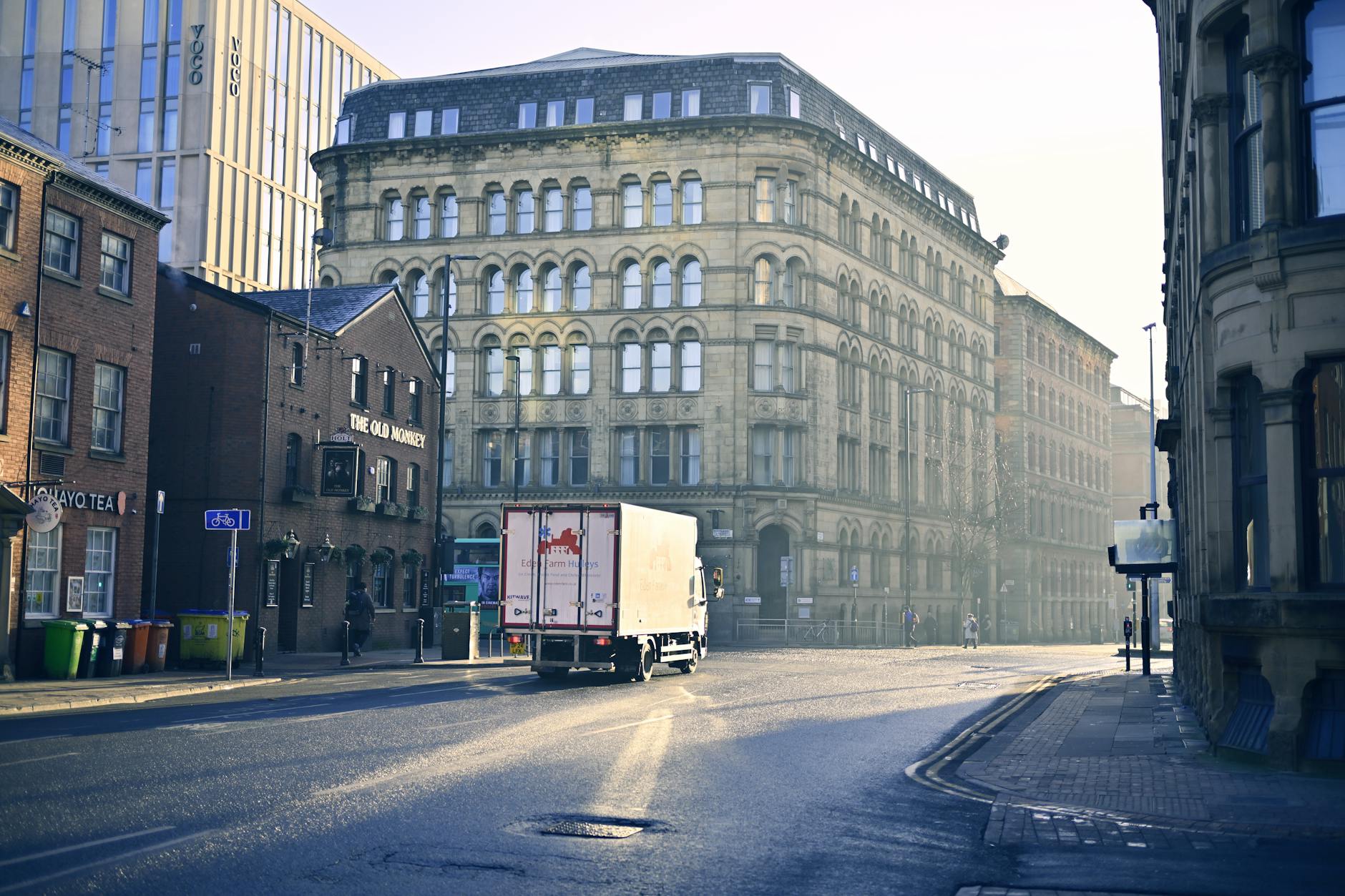 Quiet Manchester street with historic architecture in early morning light