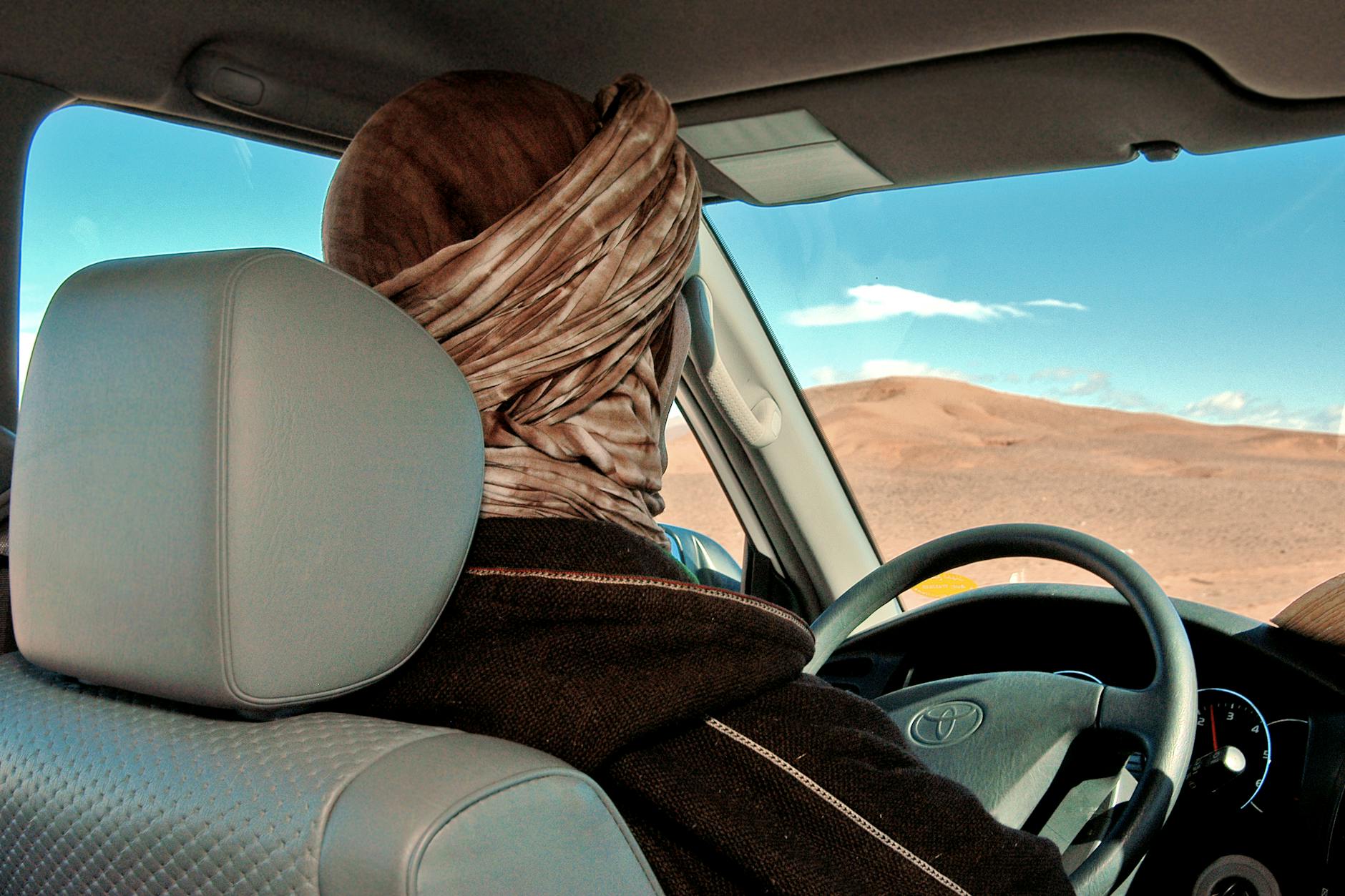 Driver on an Agafay desert road trip route