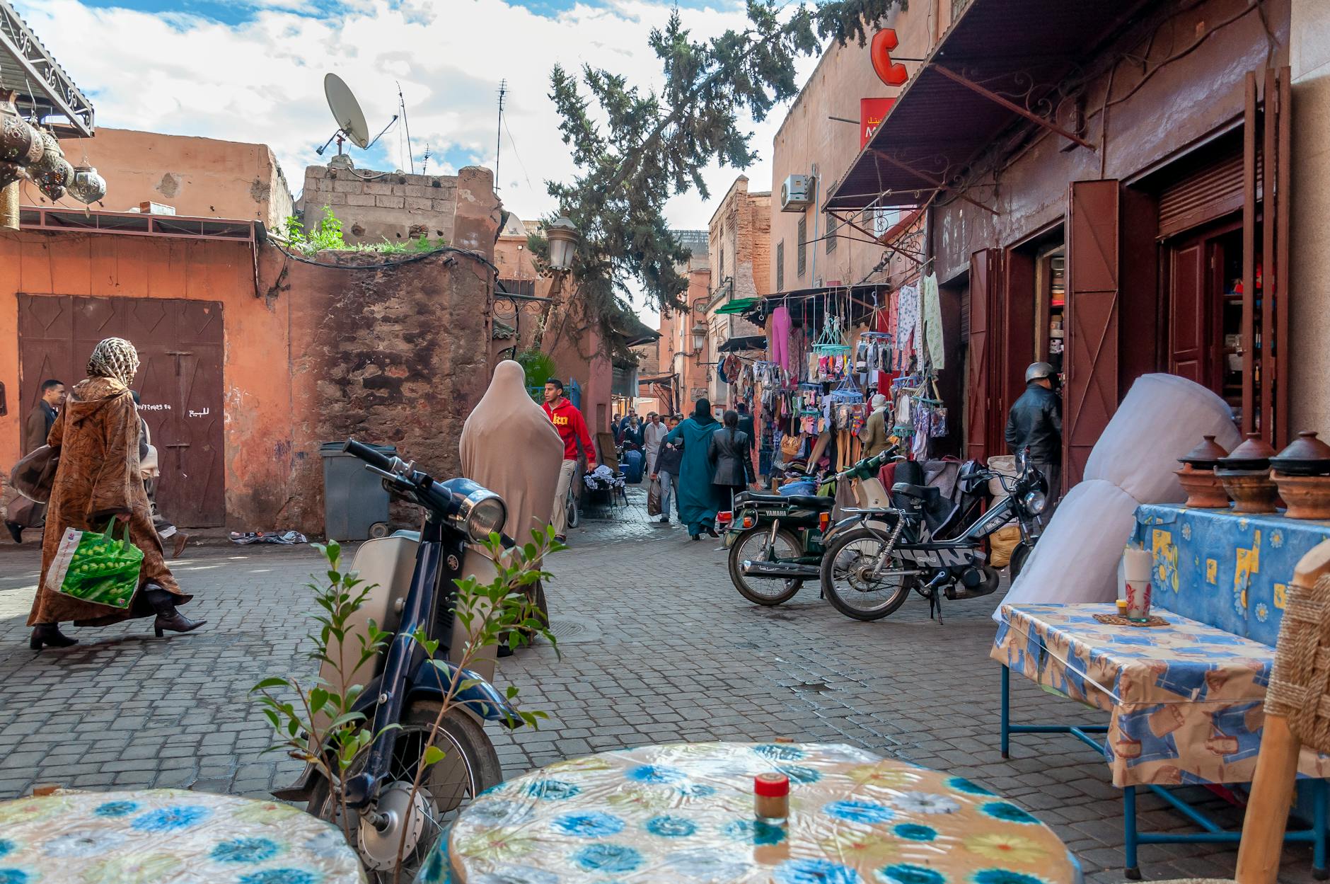 People walking across a paved square in old Marrakesh