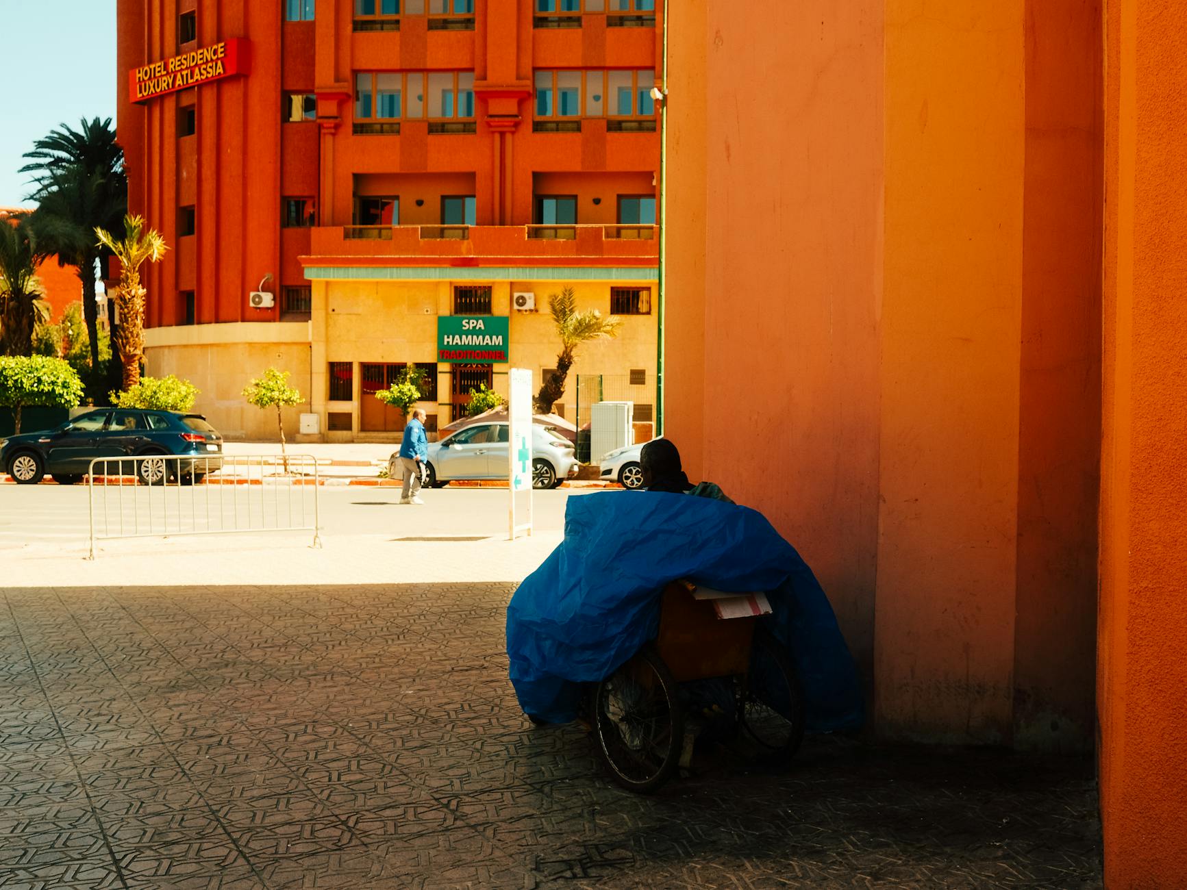 Marrakech street scene with a hotel and cycle rickshaw