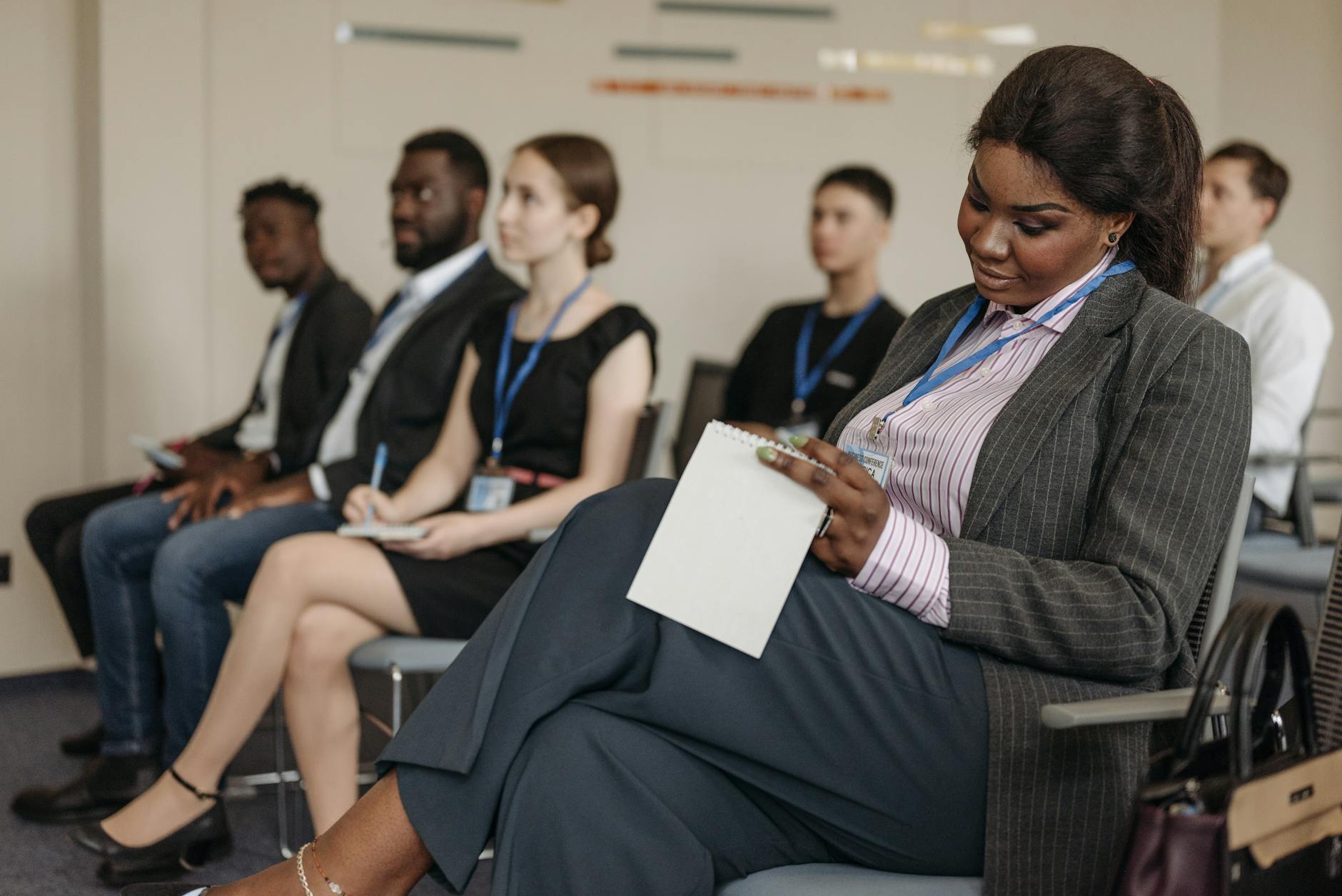 Conference attendee taking notes during a business seminar