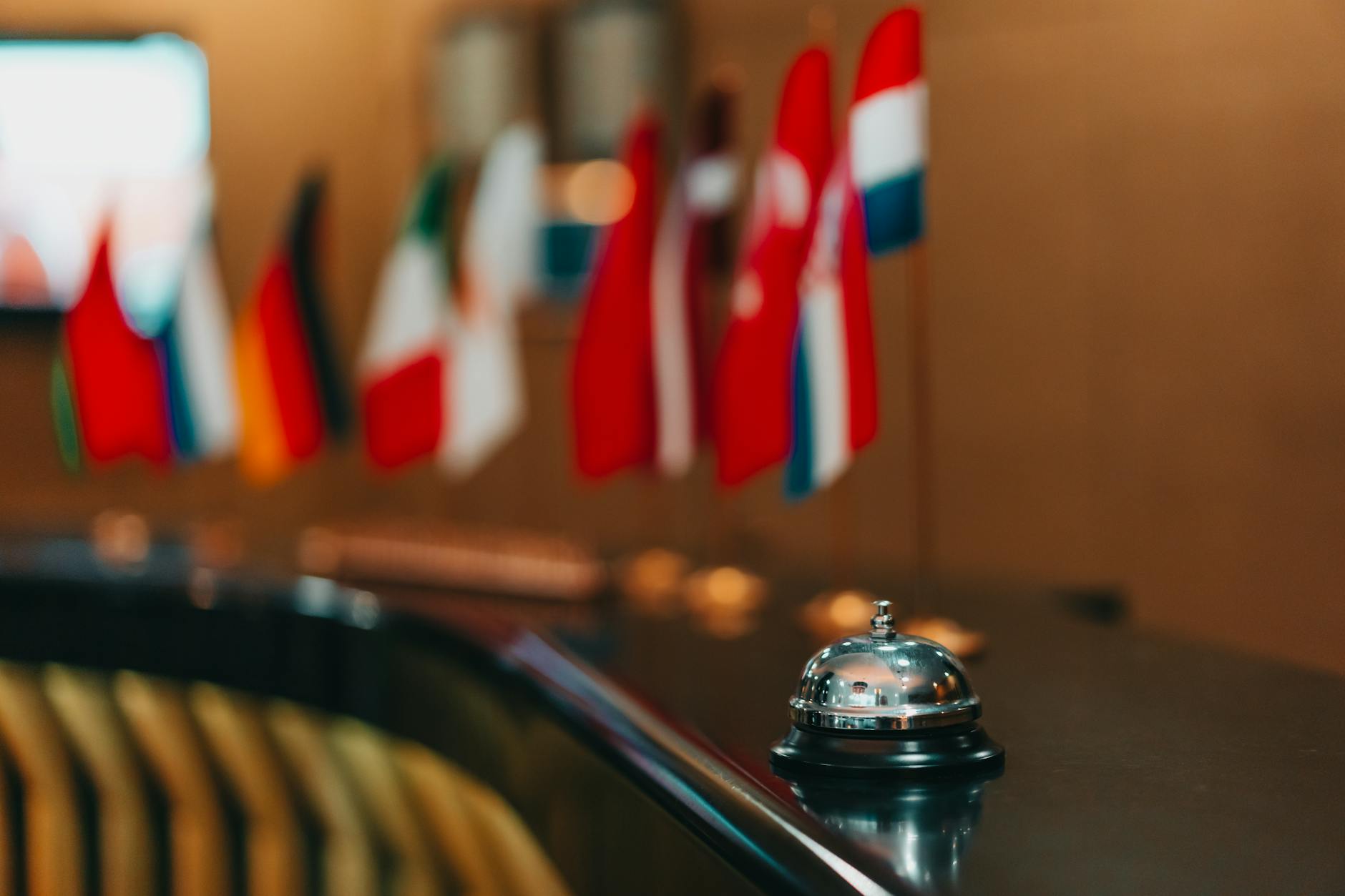 Hotel reception bell with international flags in the background